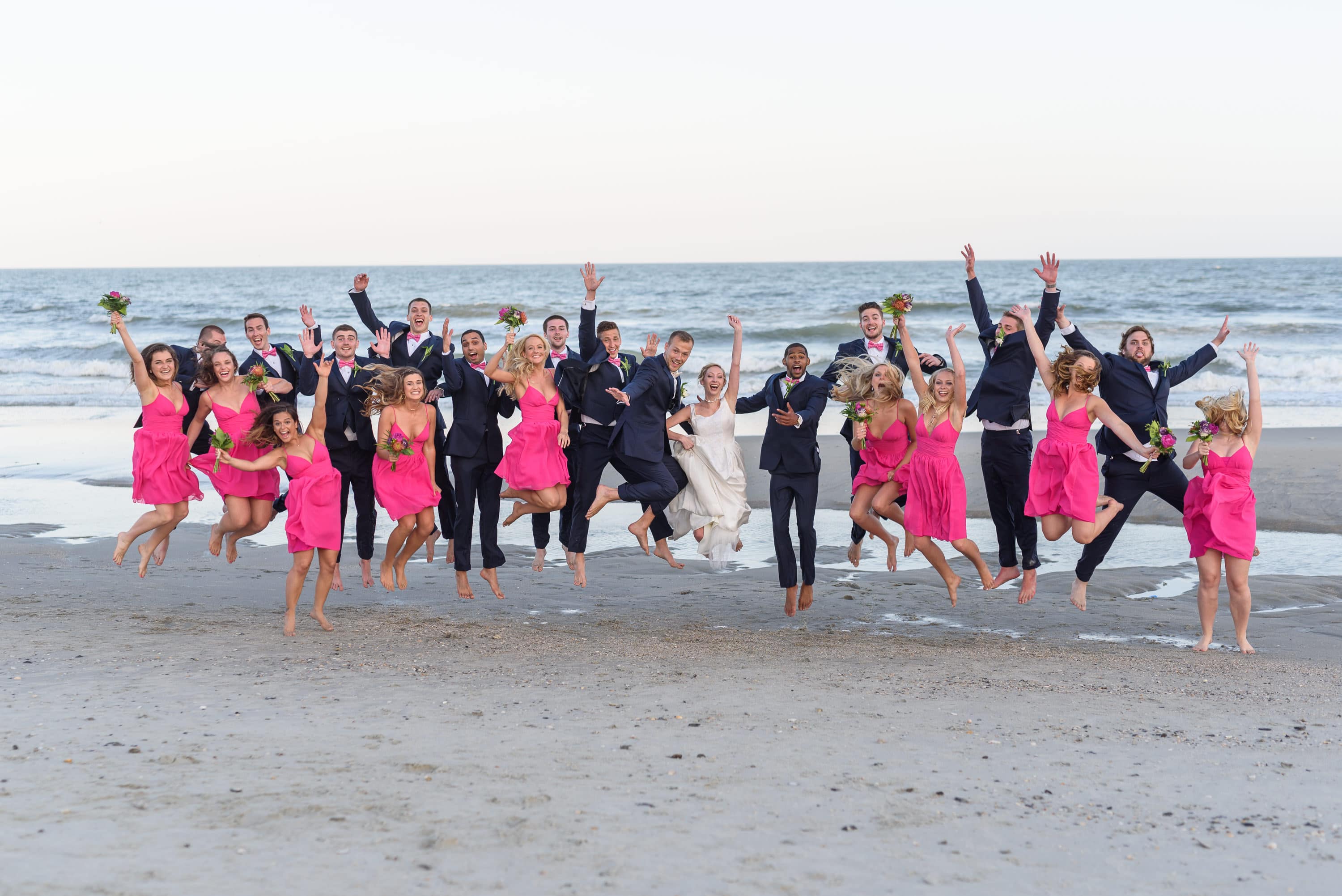 Bridal party jumping in front of the ocean -  Grande Dunes Ocean Club