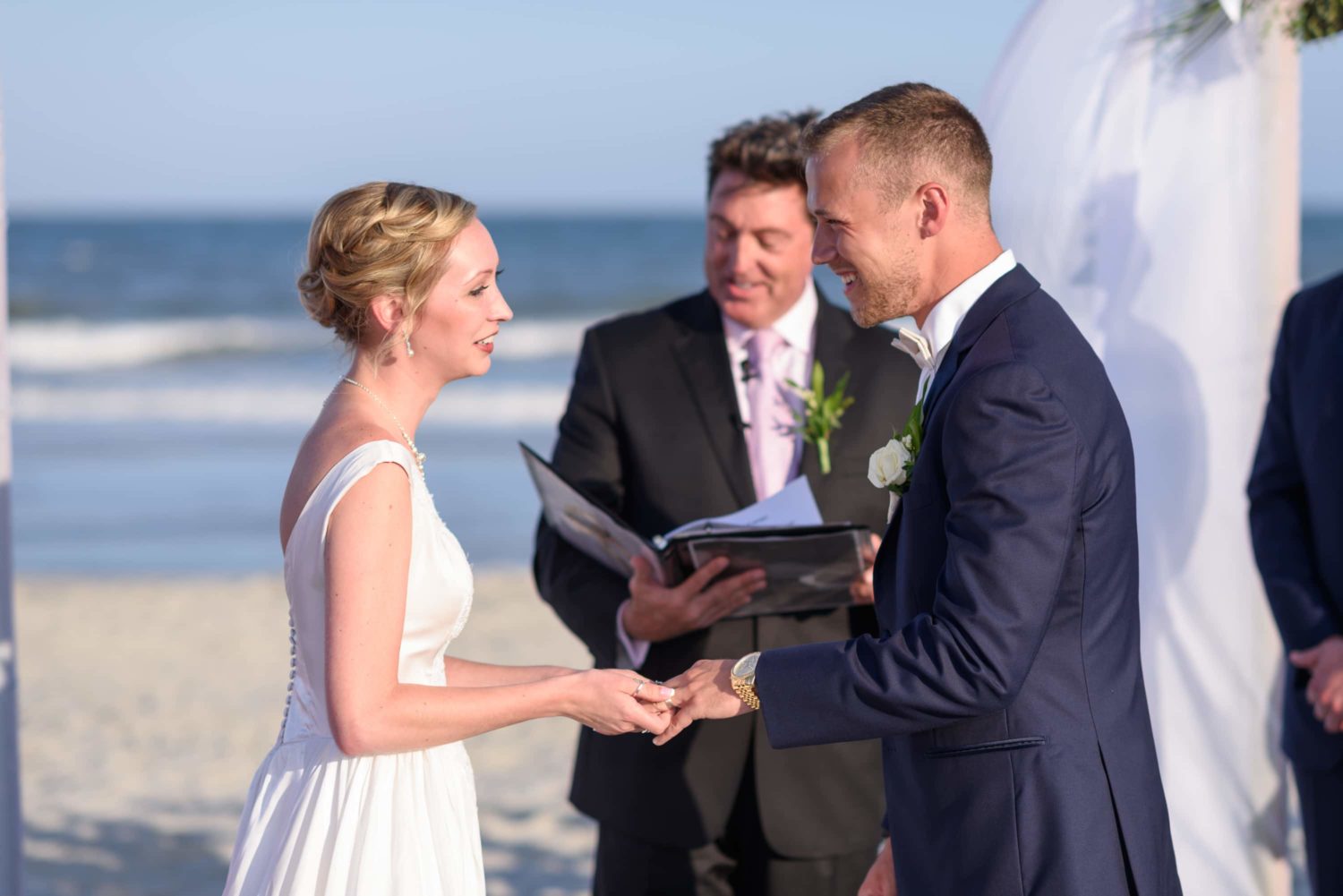 Bride and groom exchanging rings -  Grande Dunes Ocean Club