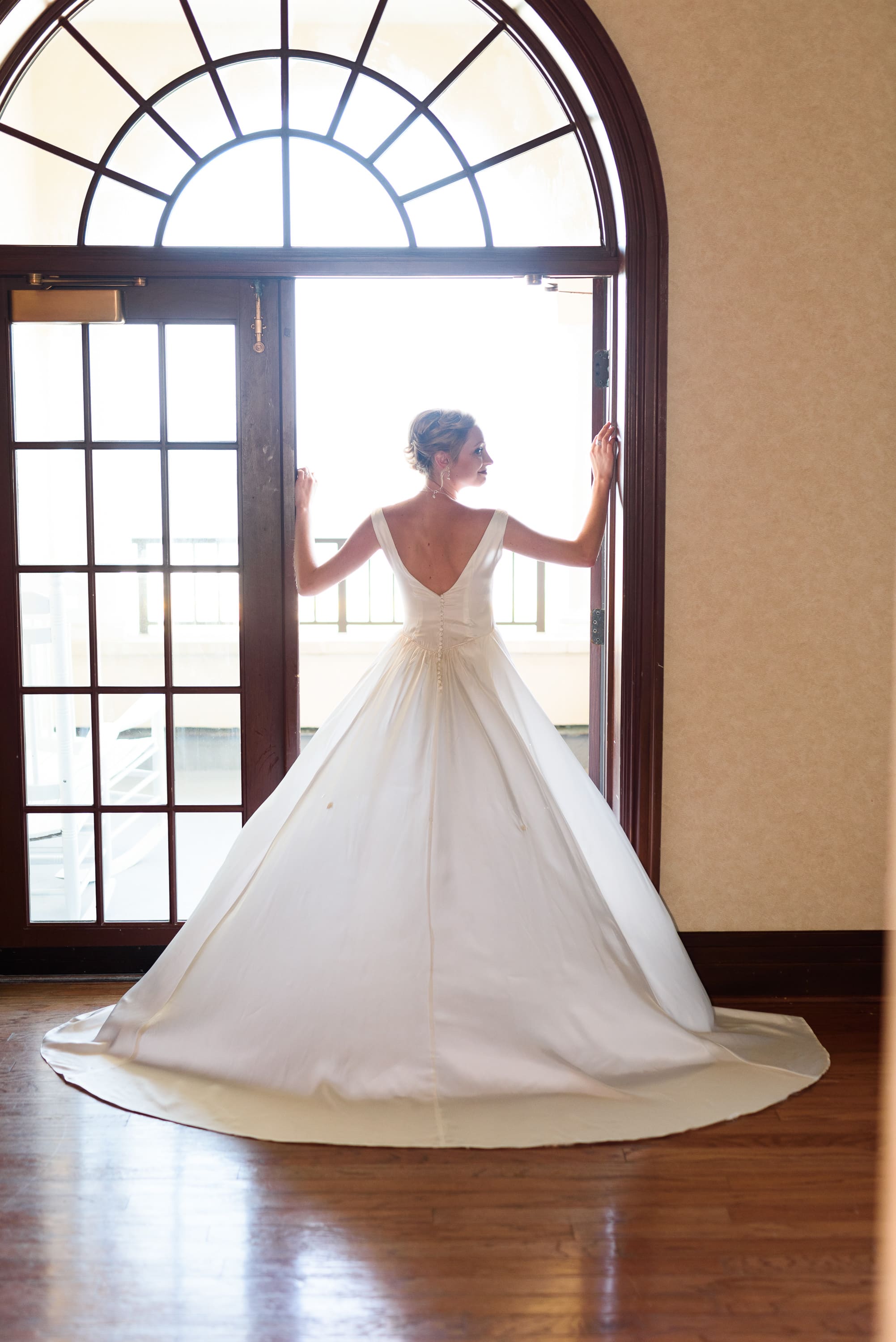 Bride standing in doorway with billowing dress -  Grande Dunes Ocean Club