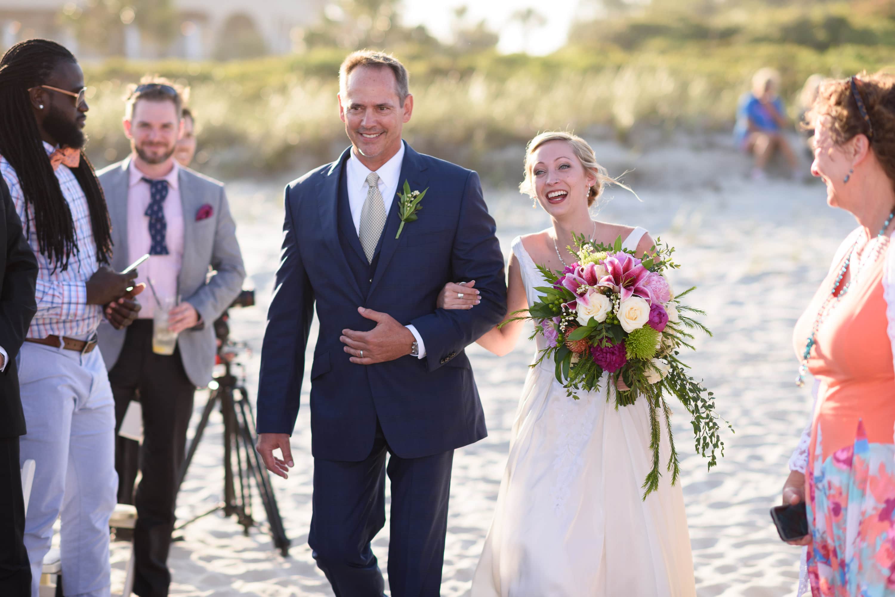 Bride walking towards ceremony with her father -  Grande Dunes Ocean Club