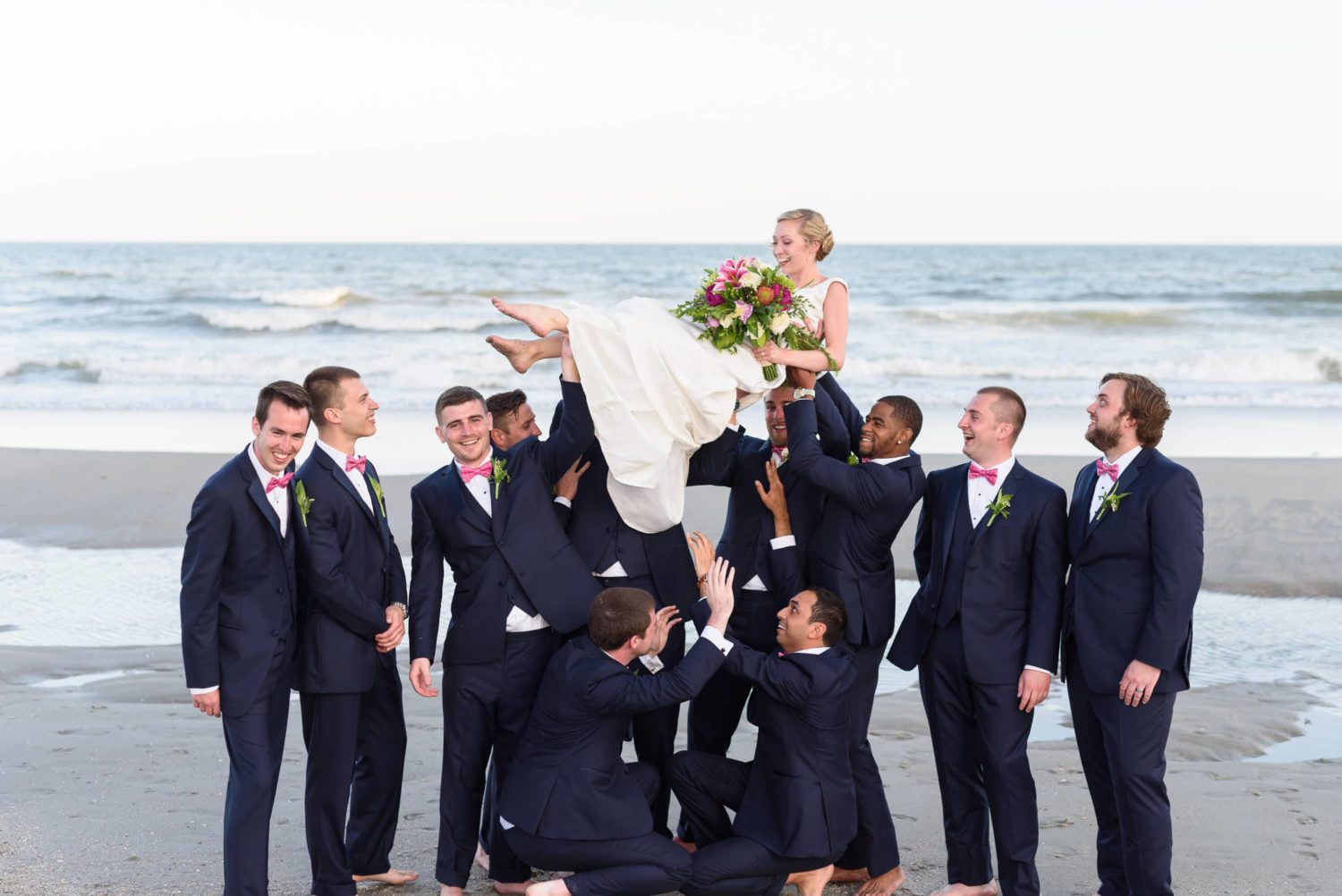 Groomsmen lifting bride too high in the air -  Grande Dunes Ocean Club