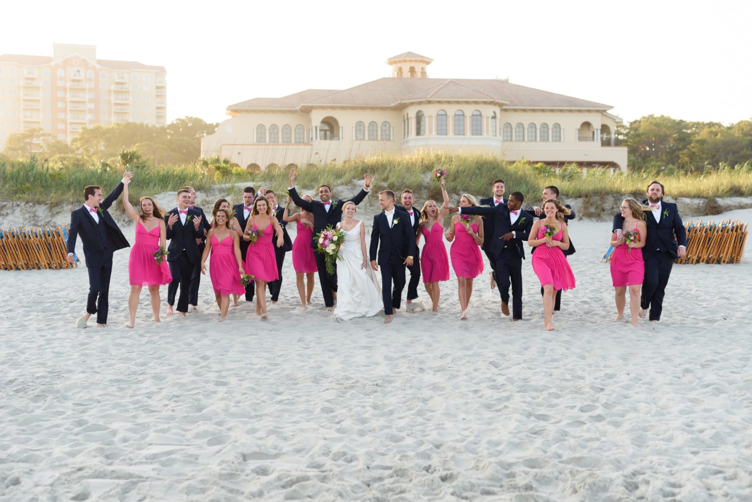 Happy bridal party walking down the beach -  Grande Dunes Ocean Club