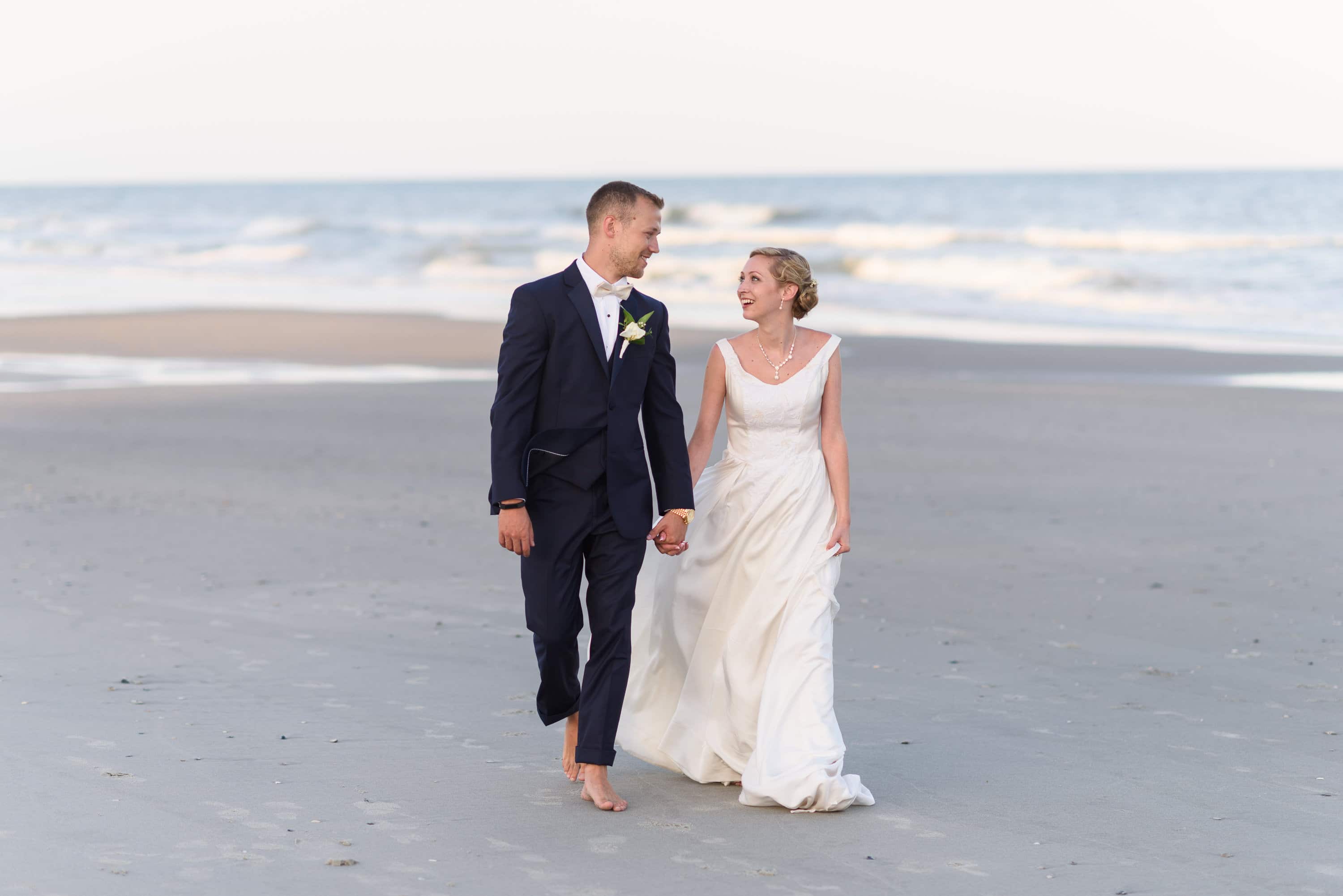Happy couple walking down the beach -  Grande Dunes Ocean Club