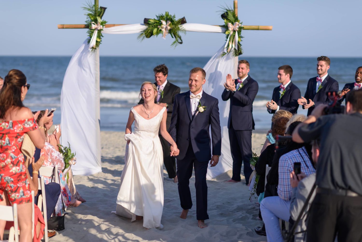 Happy just married couple walking down isle -  Grande Dunes Ocean Club