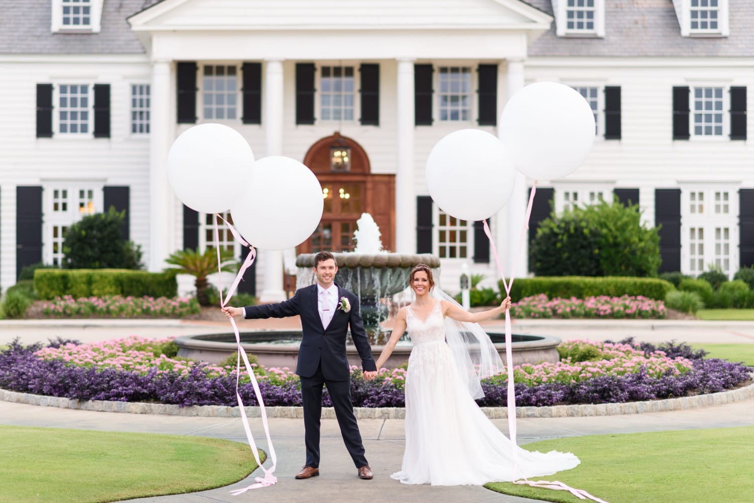 Bride and groom holding large white balloons  Pine Lakes Country Club