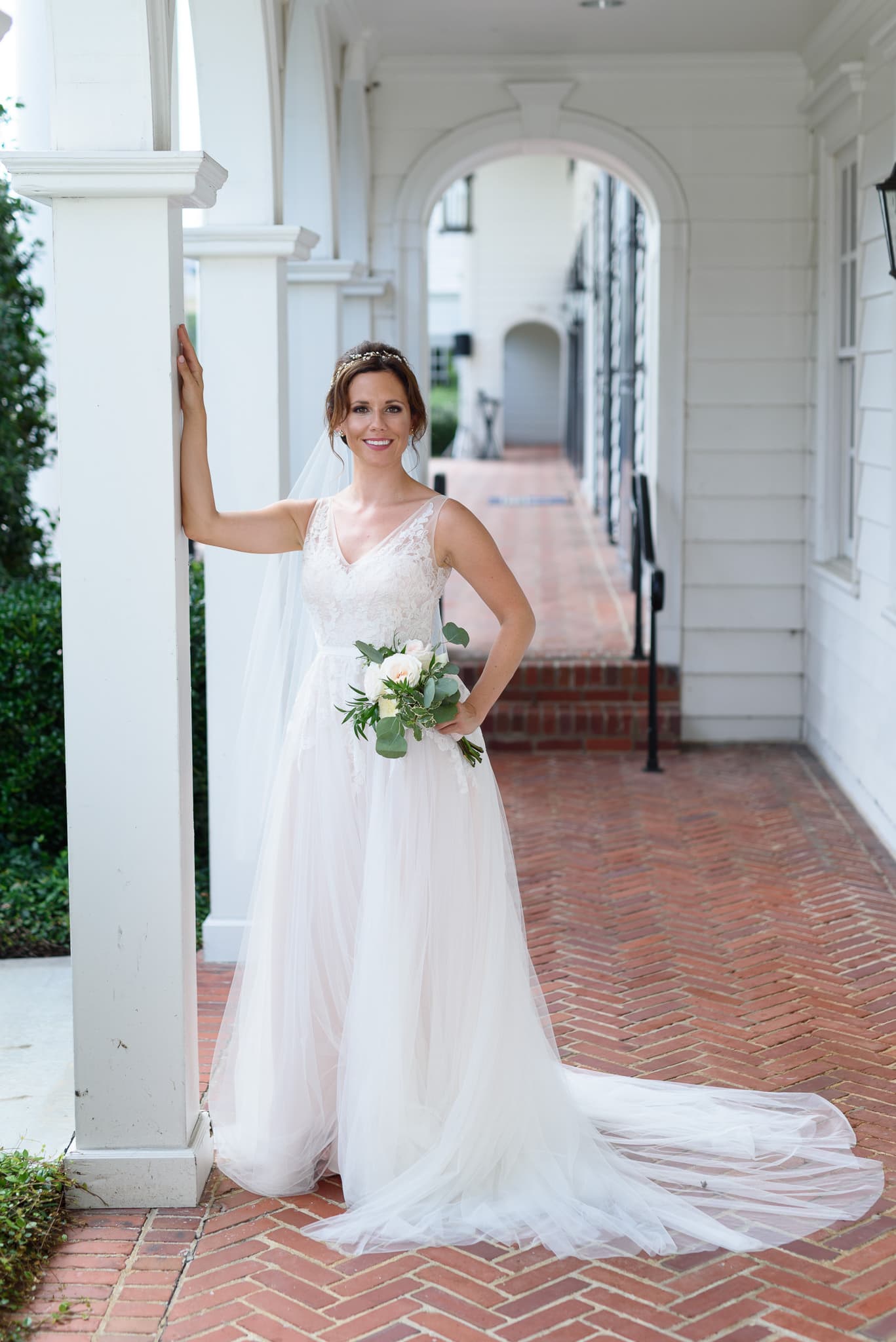 Bride leaning against columns Pine Lakes Country Club