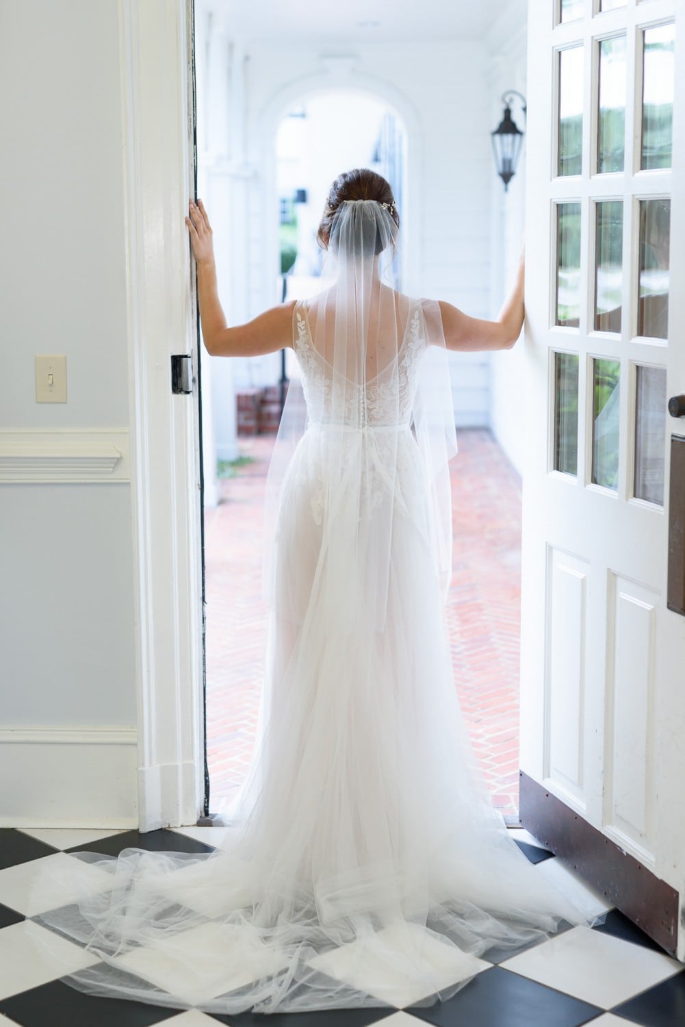 Bride looking out of doorway Pine Lakes Country Club