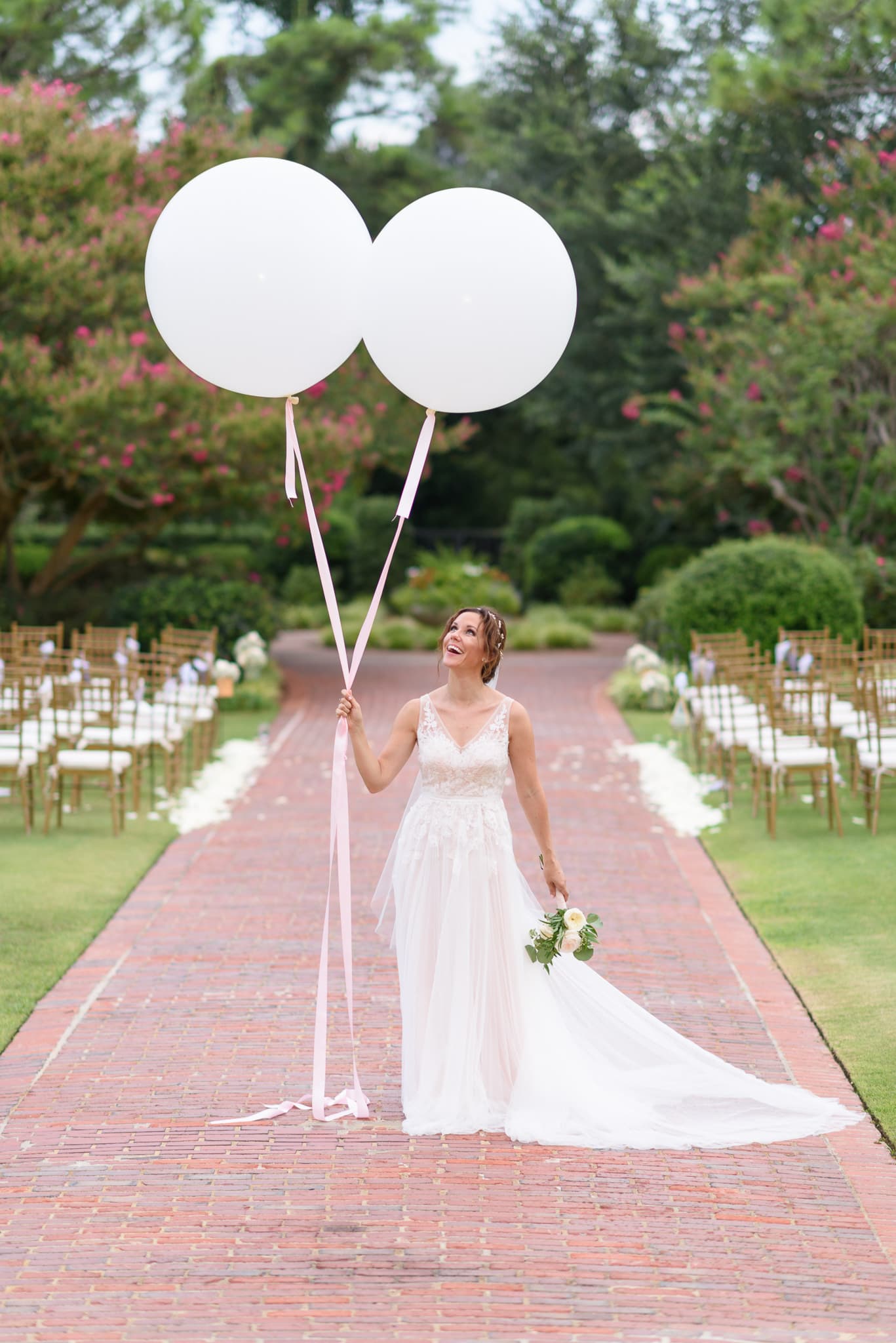 Bride looking up at large balloons Pine Lakes Country Club