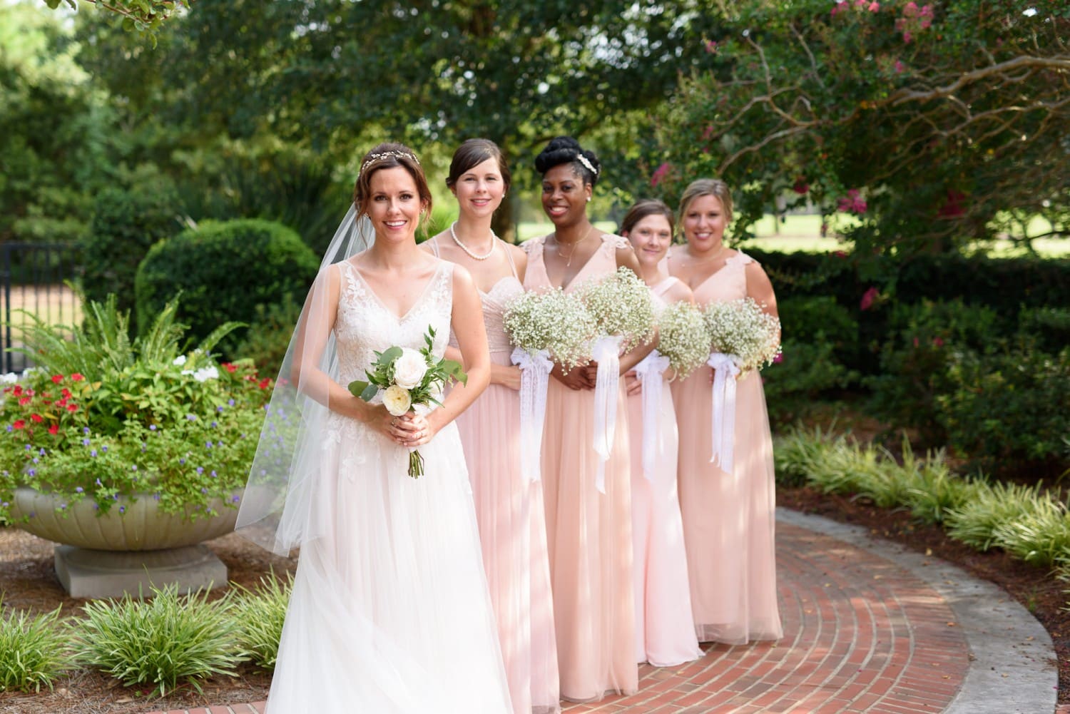 Bride standing with bridesmaids in background Pine Lakes Country Club