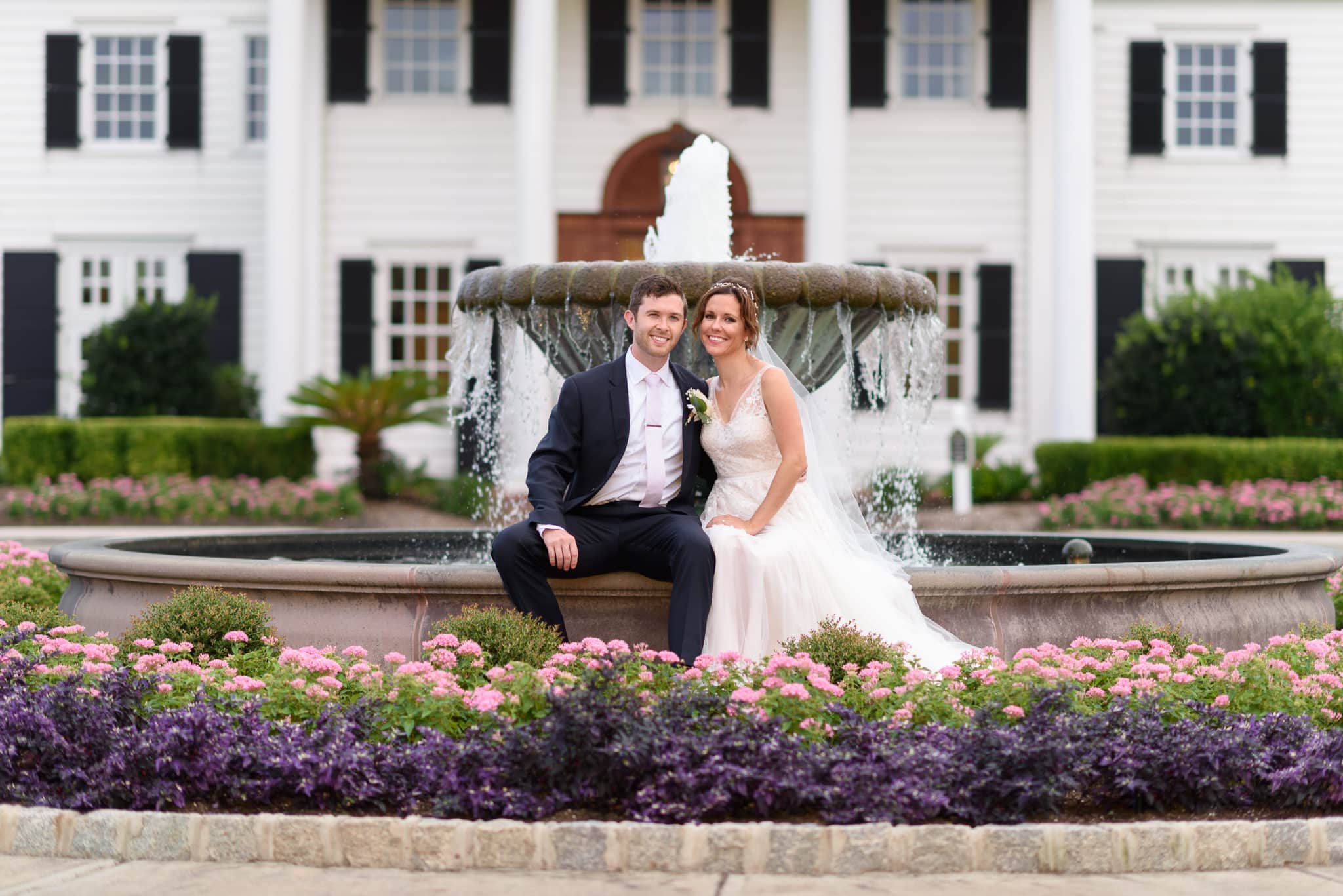 Couple sitting by the fountain Pine Lakes Country Club