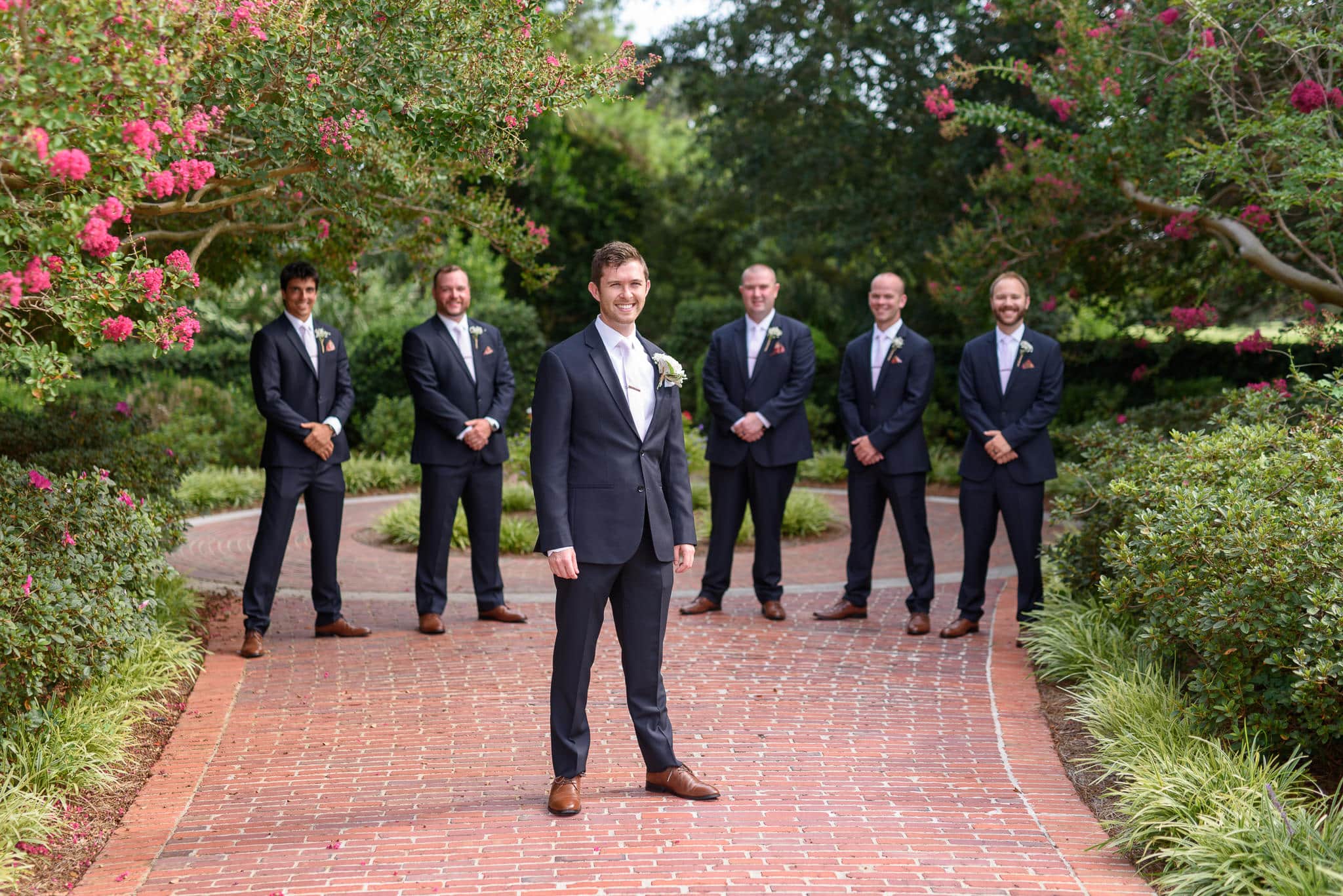 Groom with groomsmen standing in the background Pine Lakes Country Club