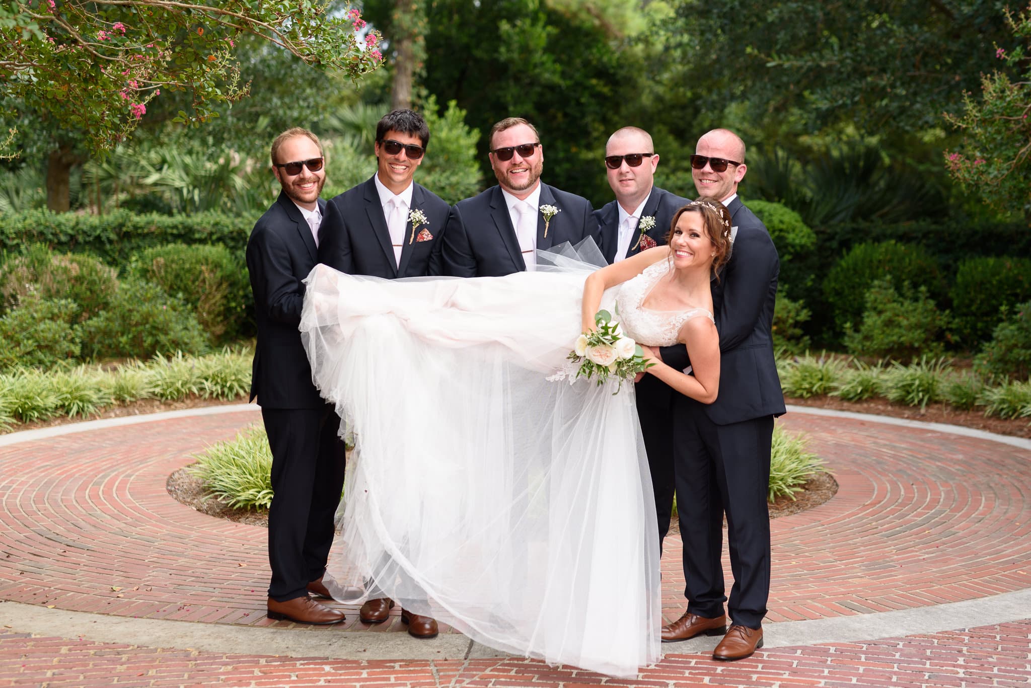 Groomsmen in sunglasses lifting up the bride Pine Lakes Country Club