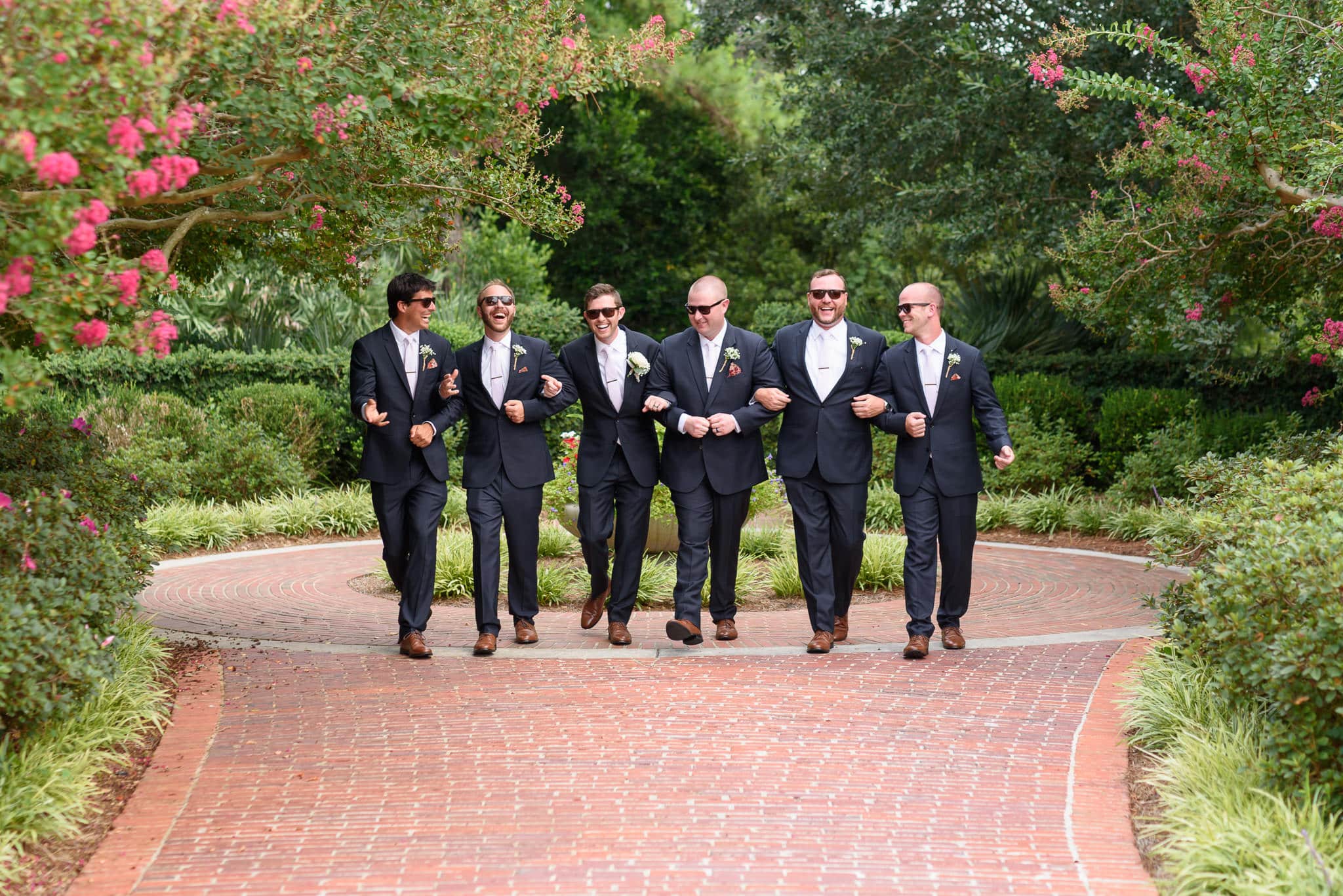 Groomsmen walking together holding arms Pine Lakes Country Club
