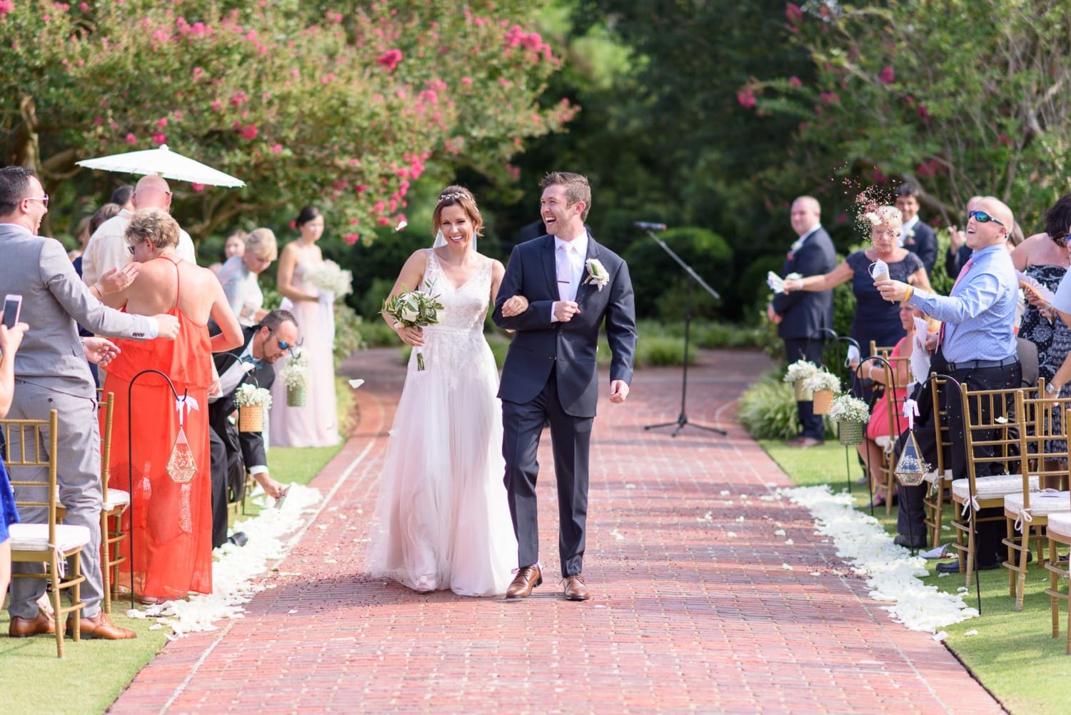 Happy bride and groom walking down isle after ceremony Pine Lakes Country Club