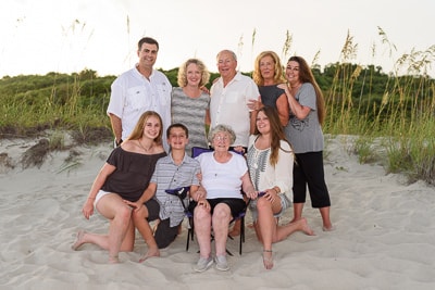 Family with grandparents in front of dunes Myrtle Beach