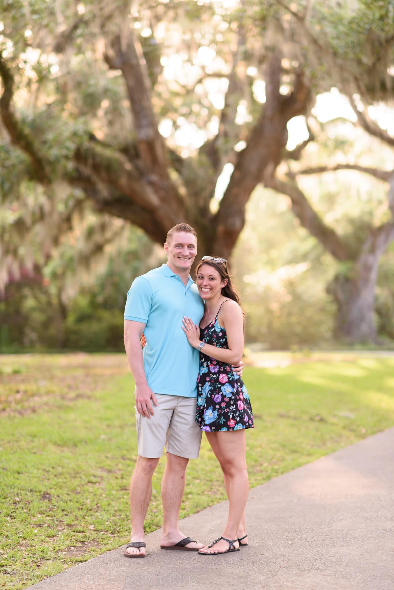 Just engaged couple in front of the oak trees - Brookgreen Gardens