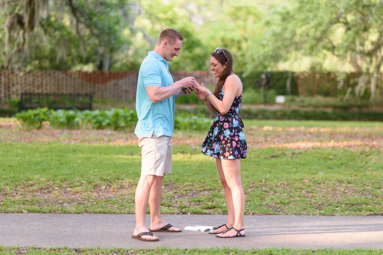 Putting on the ring after proposal - Brookgreen Gardens