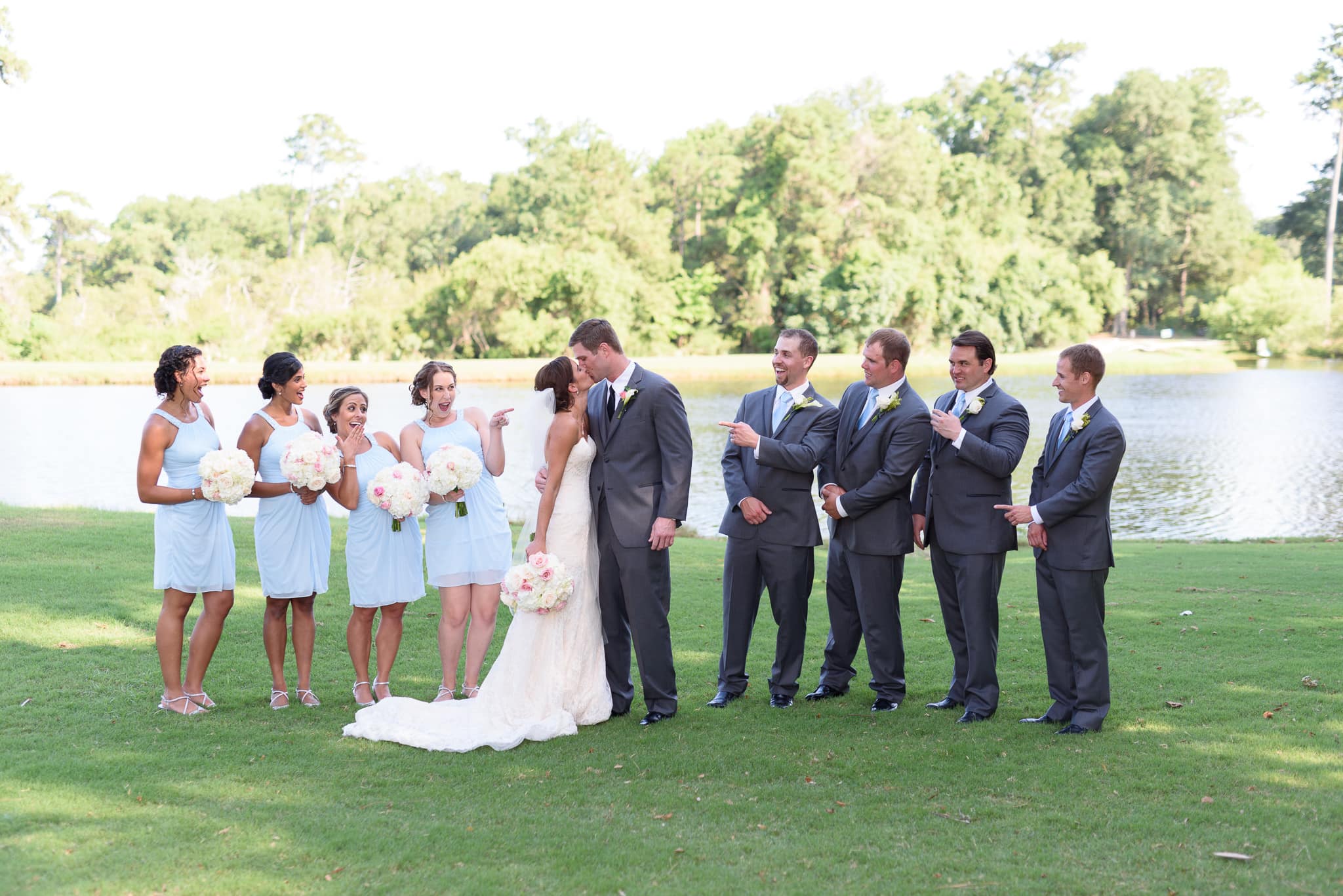Bride and groom kissing with bridal party - Pawleys Plantation