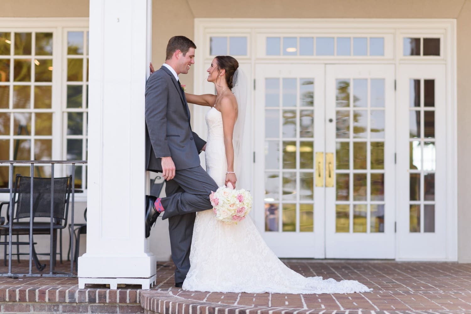 Bride and groom leaning against column - Pawleys Plantation