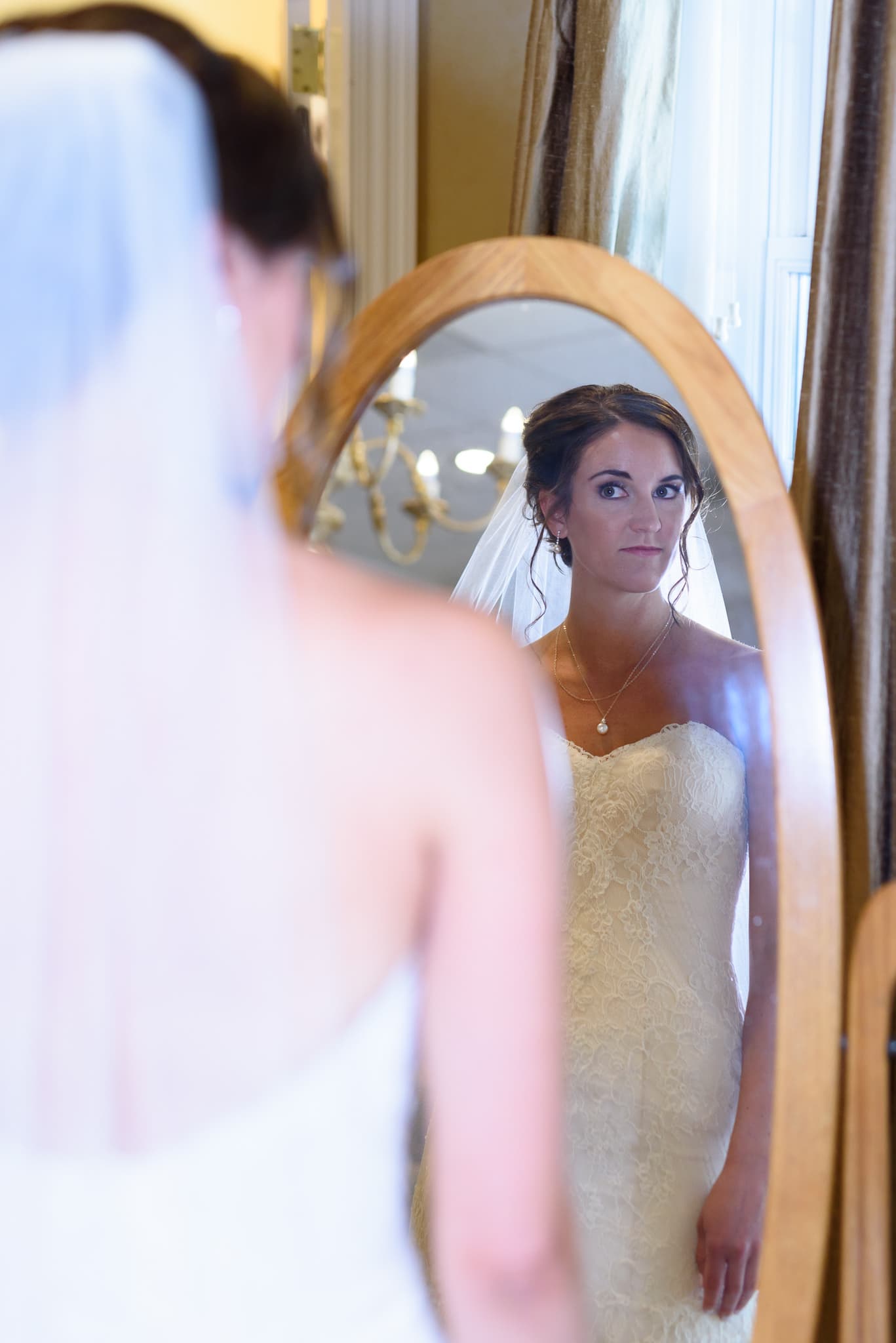 Bride checking out herself in mirror - Pawleys Plantation