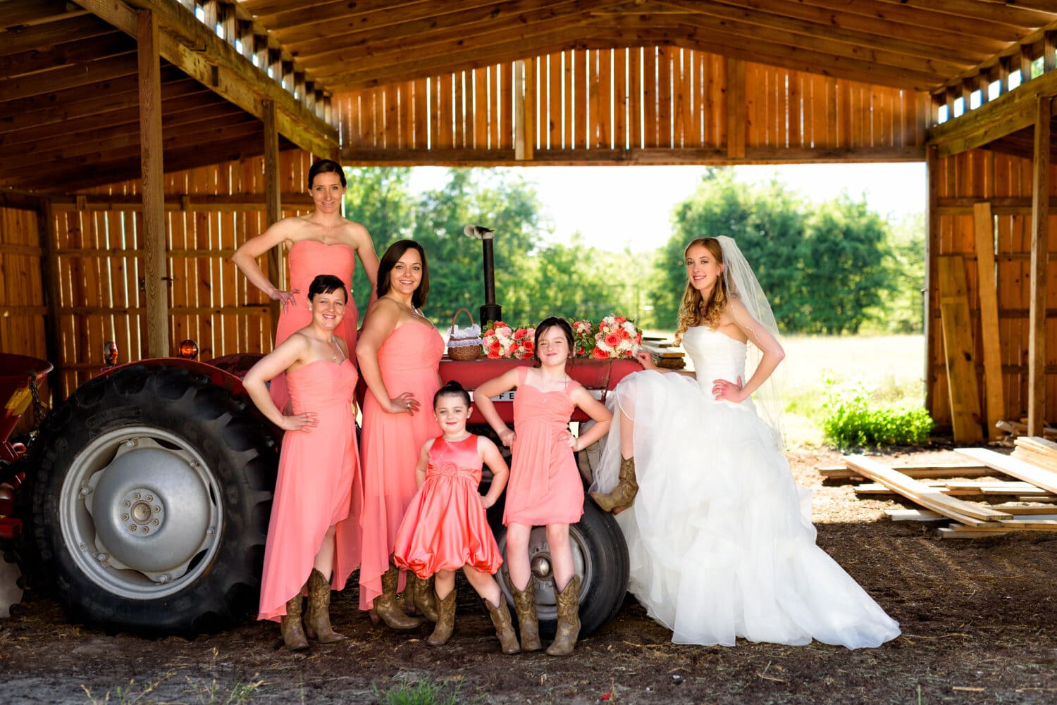 Bridesmaids posing around the tractor - Wildberry Farm