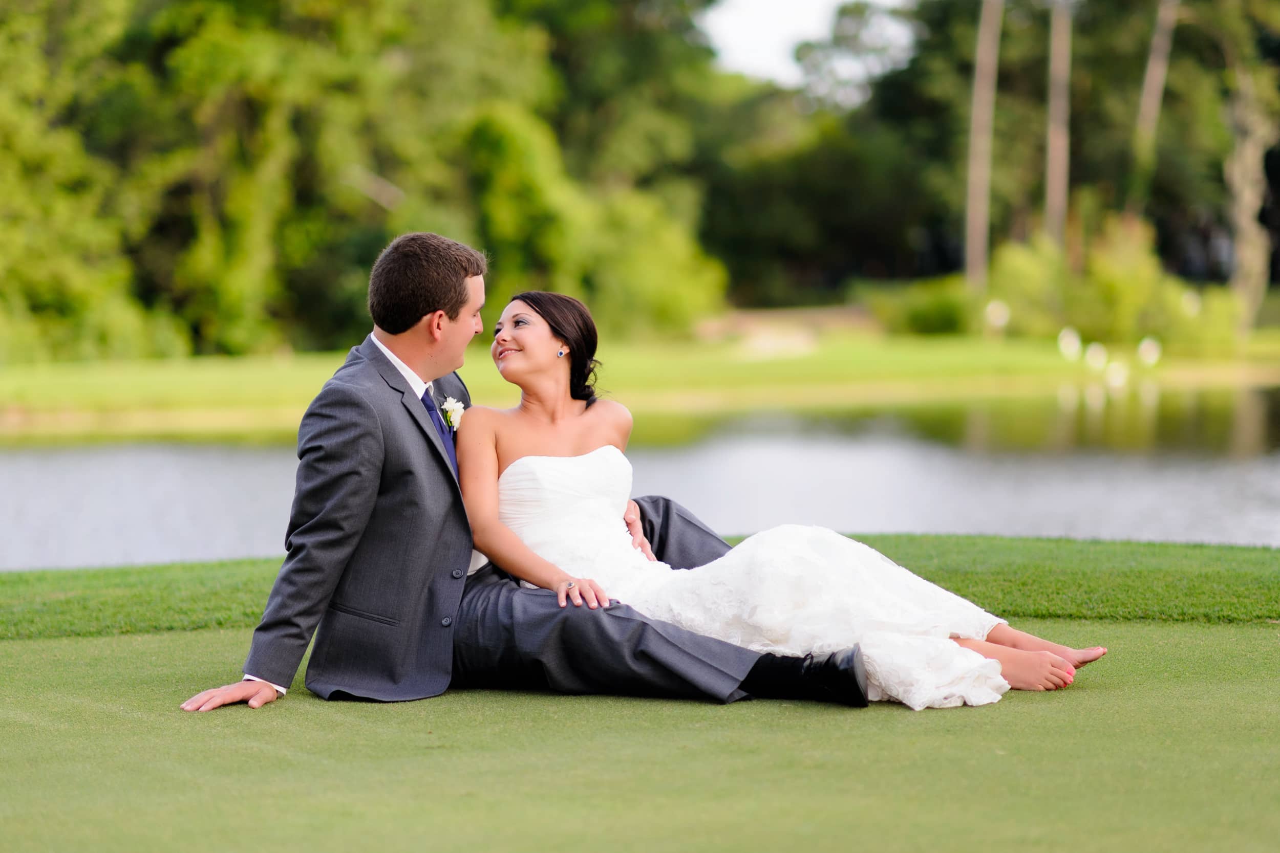 Couple laying together on the golf course greens - Pawleys Plantation