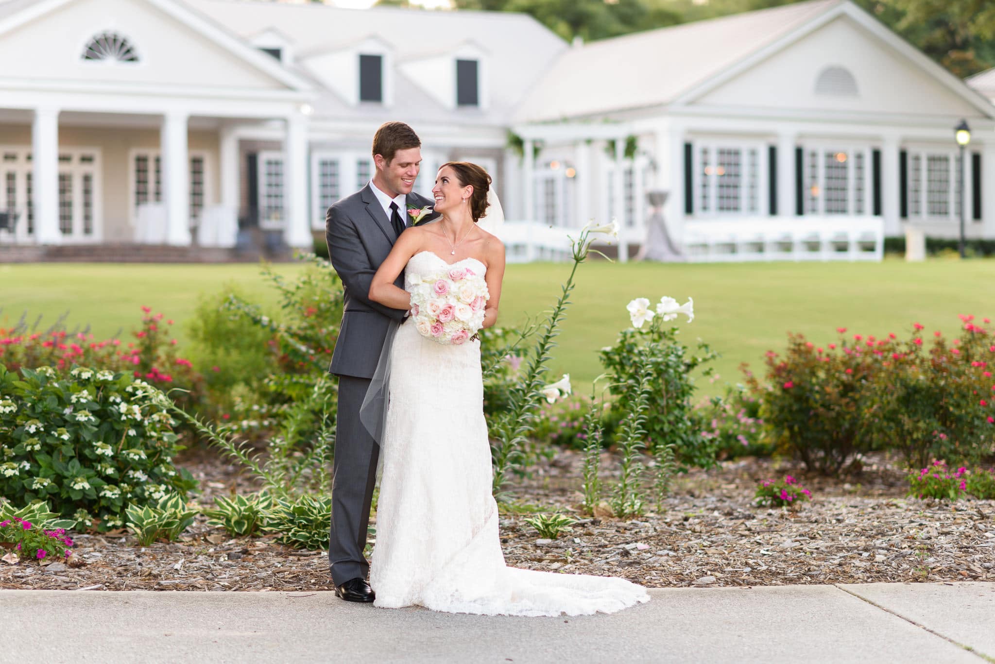 Couple smiling at each other behind clubhouse - Pawleys Plantation