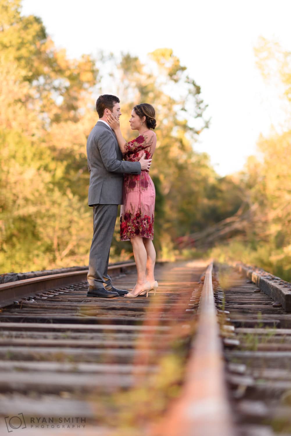 Engagement portrait close to train rail - Conway River Walk