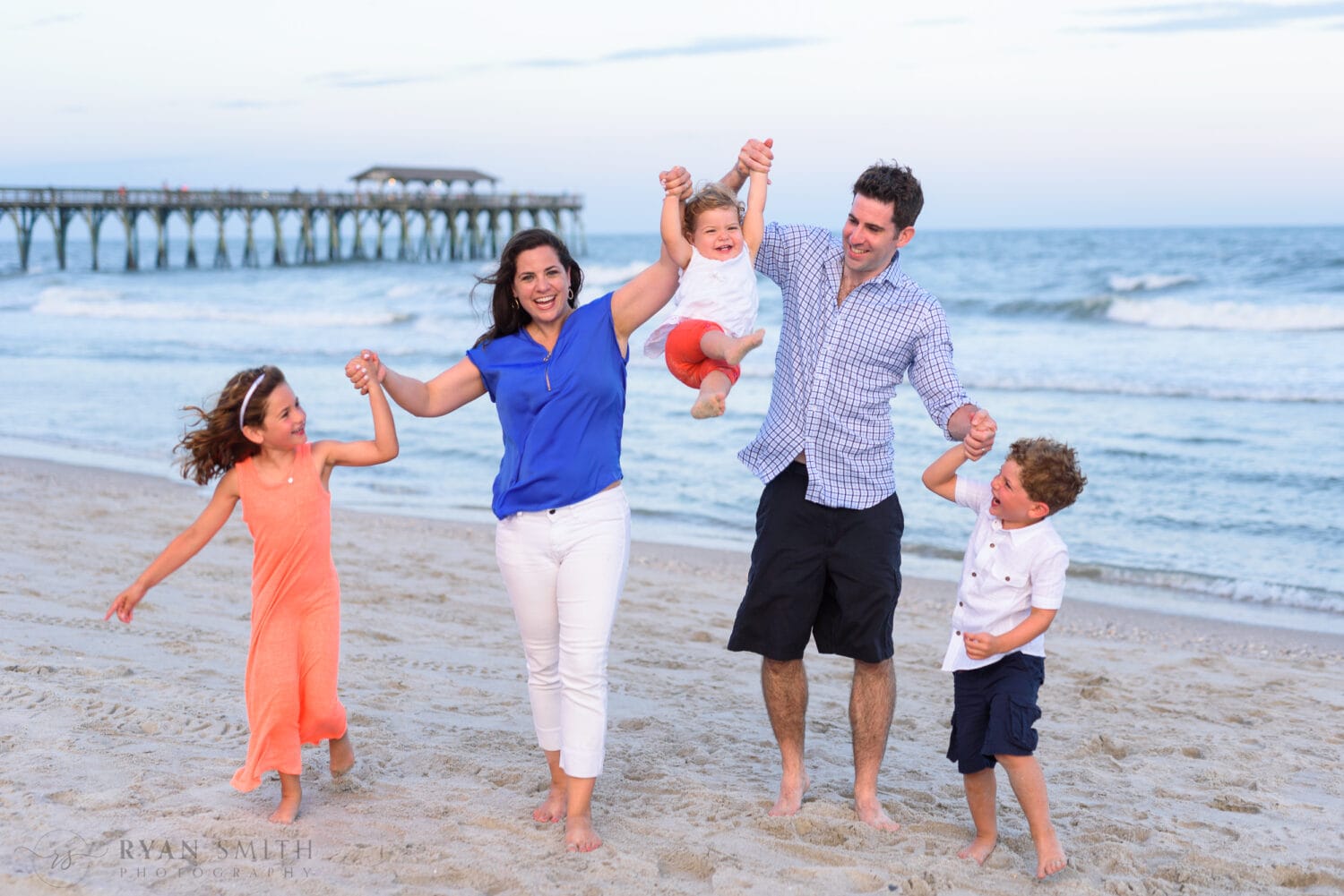 Family of 5 having fun walking from the ocean - Myrtle Beach Pier
