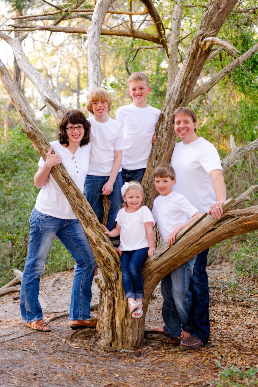 Family of six standing together around the old oak tree - Myrtle Beach State Park