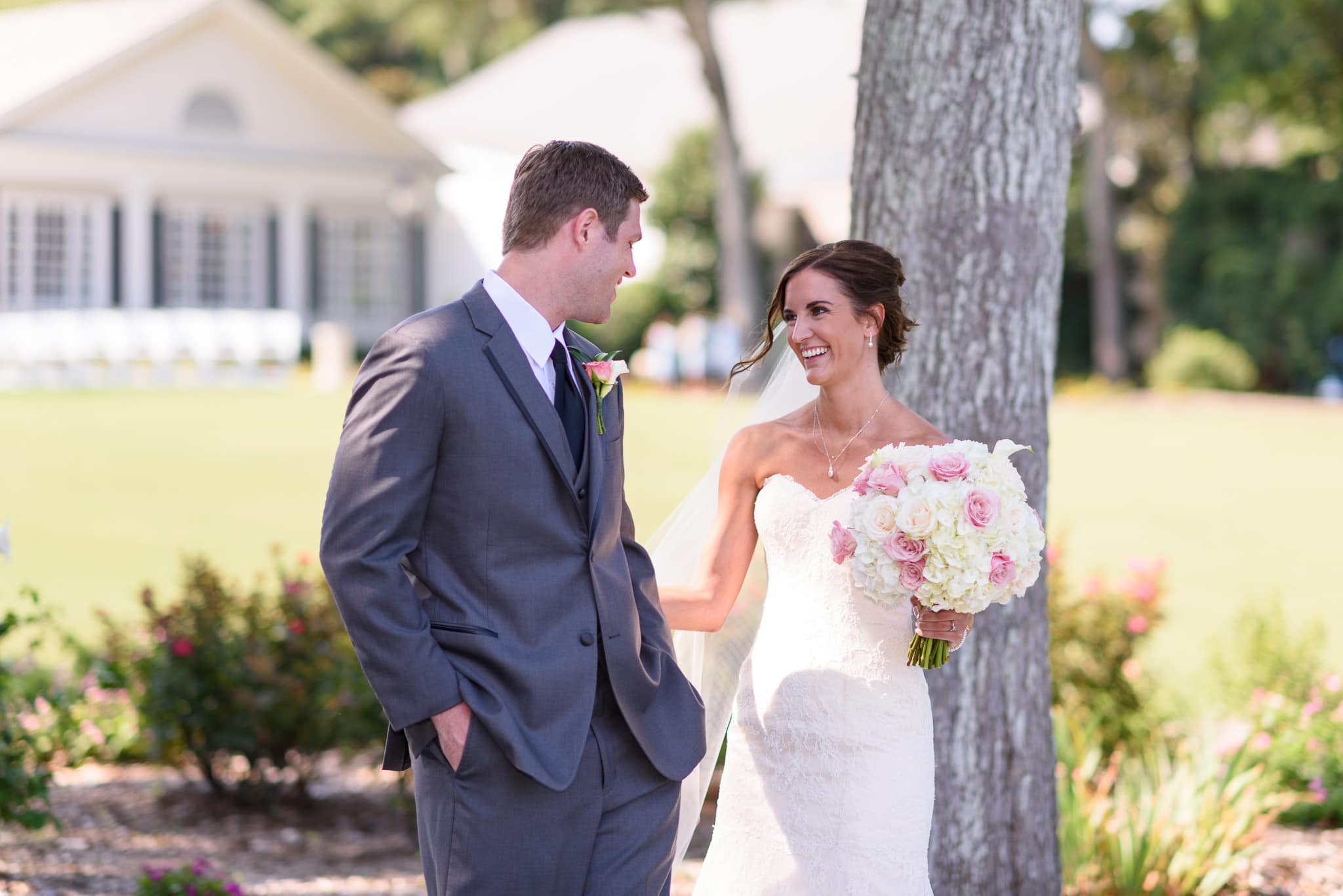 First look - Bride and groom smiling at each other for first time - Pawleys Plantation