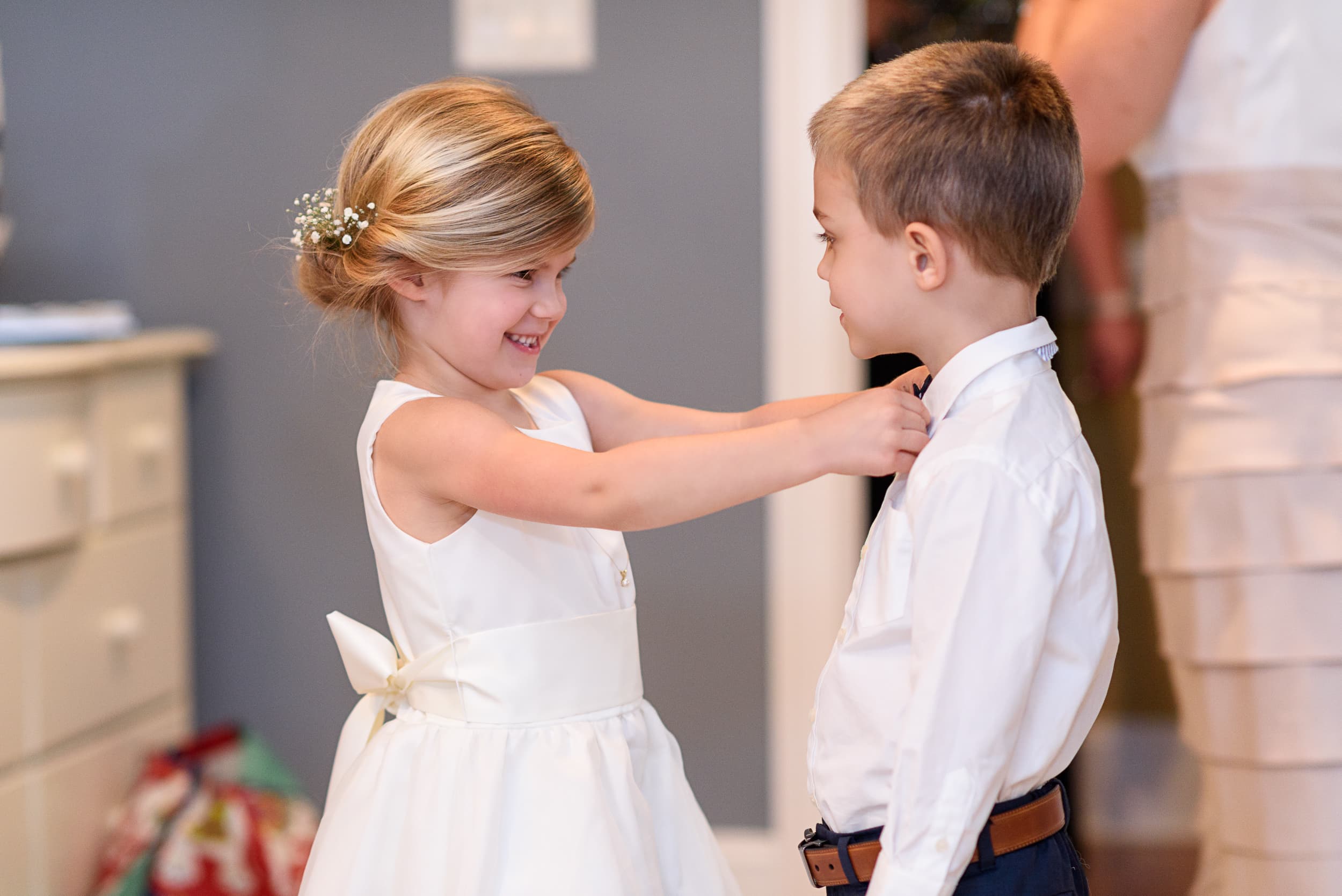 Flowergirl helping the ring bearer with his tie - Pawleys Plantation