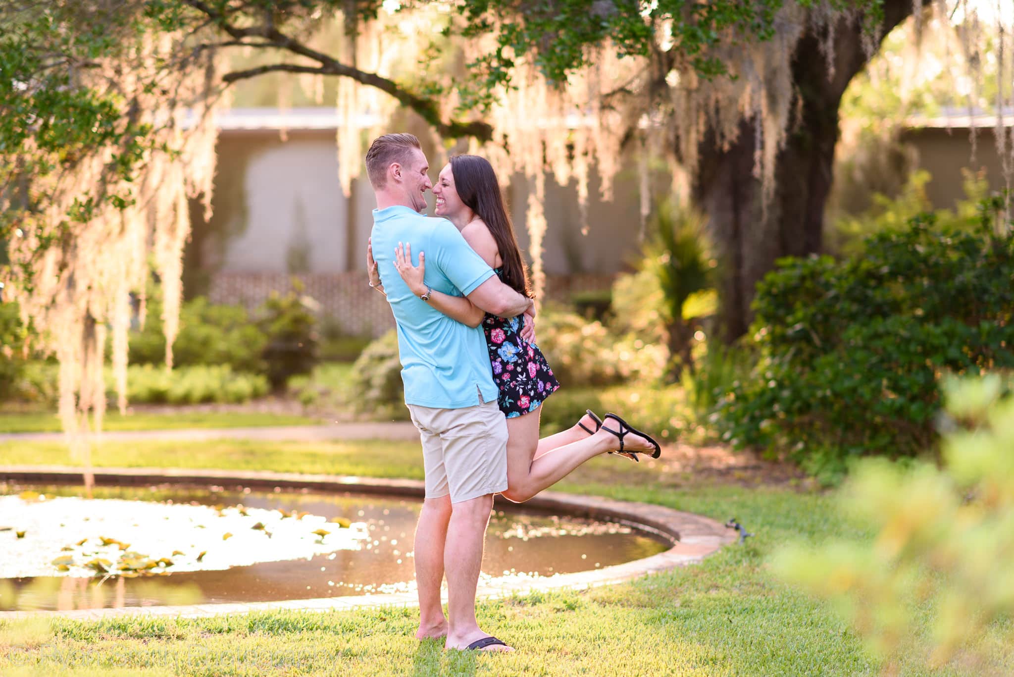 Lifting fiancé in the air for a kiss - Brookgreen Gardens
