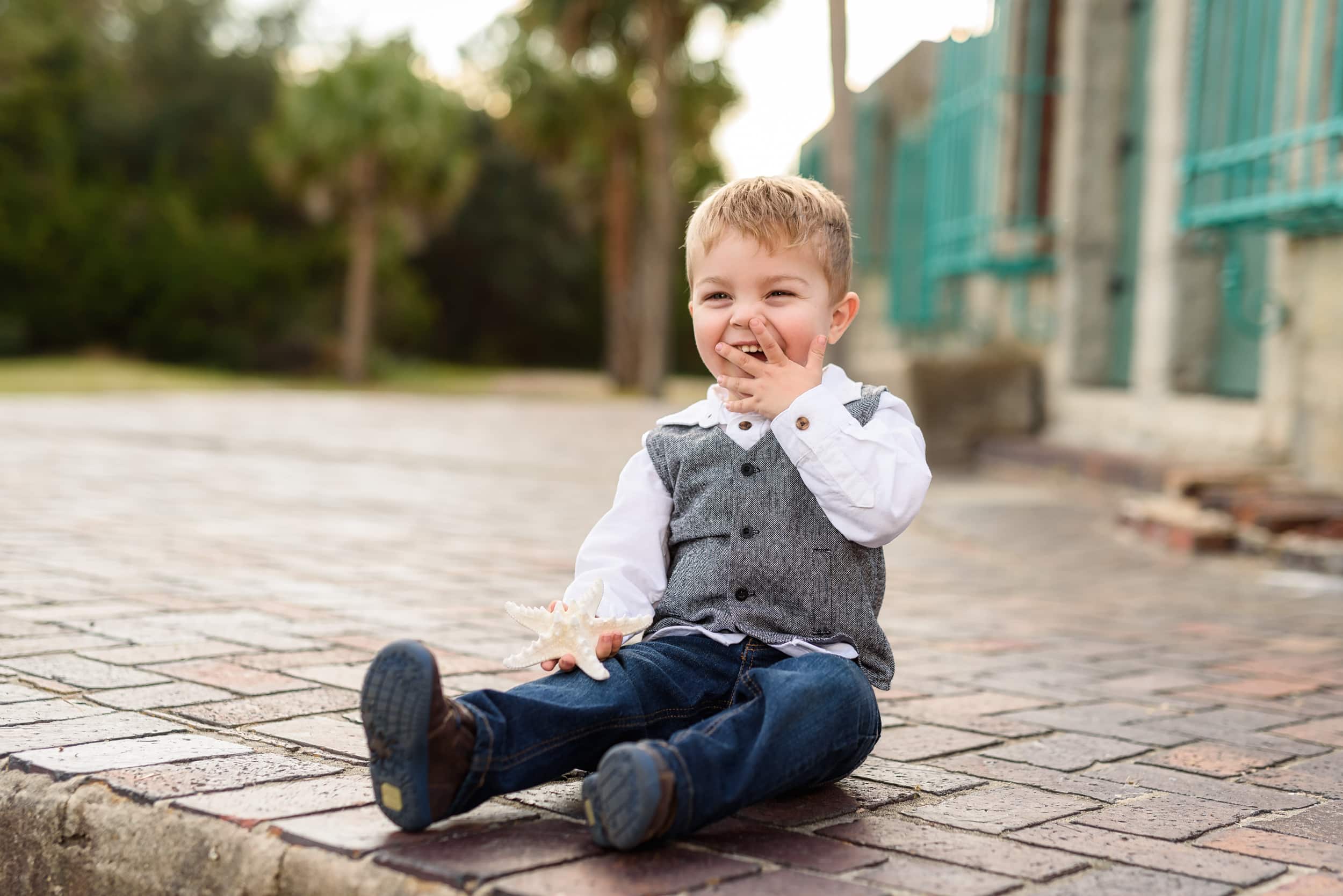 Little boy laughing at family behind the Atalaya Castle - Huntington Beach State Park
