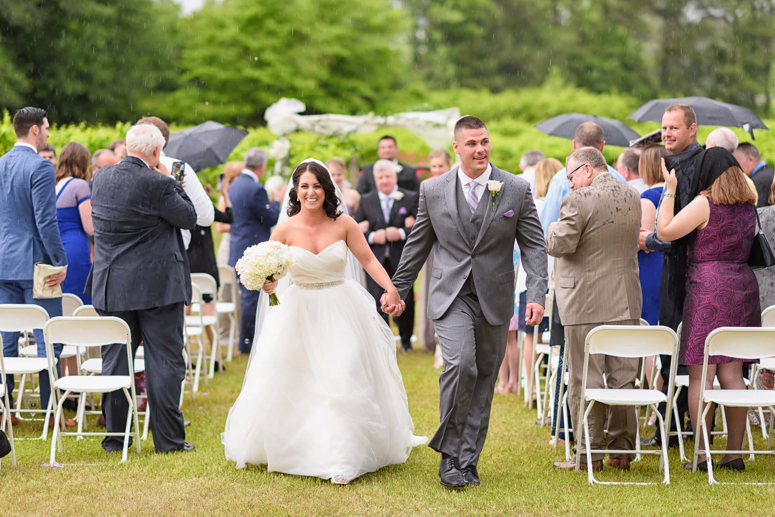 Running from the rain after the ceremony - La Belle Amie Vineyard