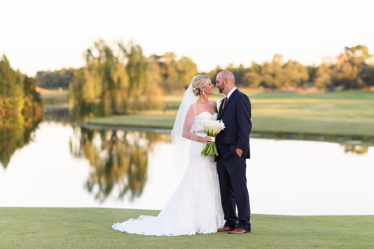 Bride and groom by golf course lake - Members Club - Grande Dunes