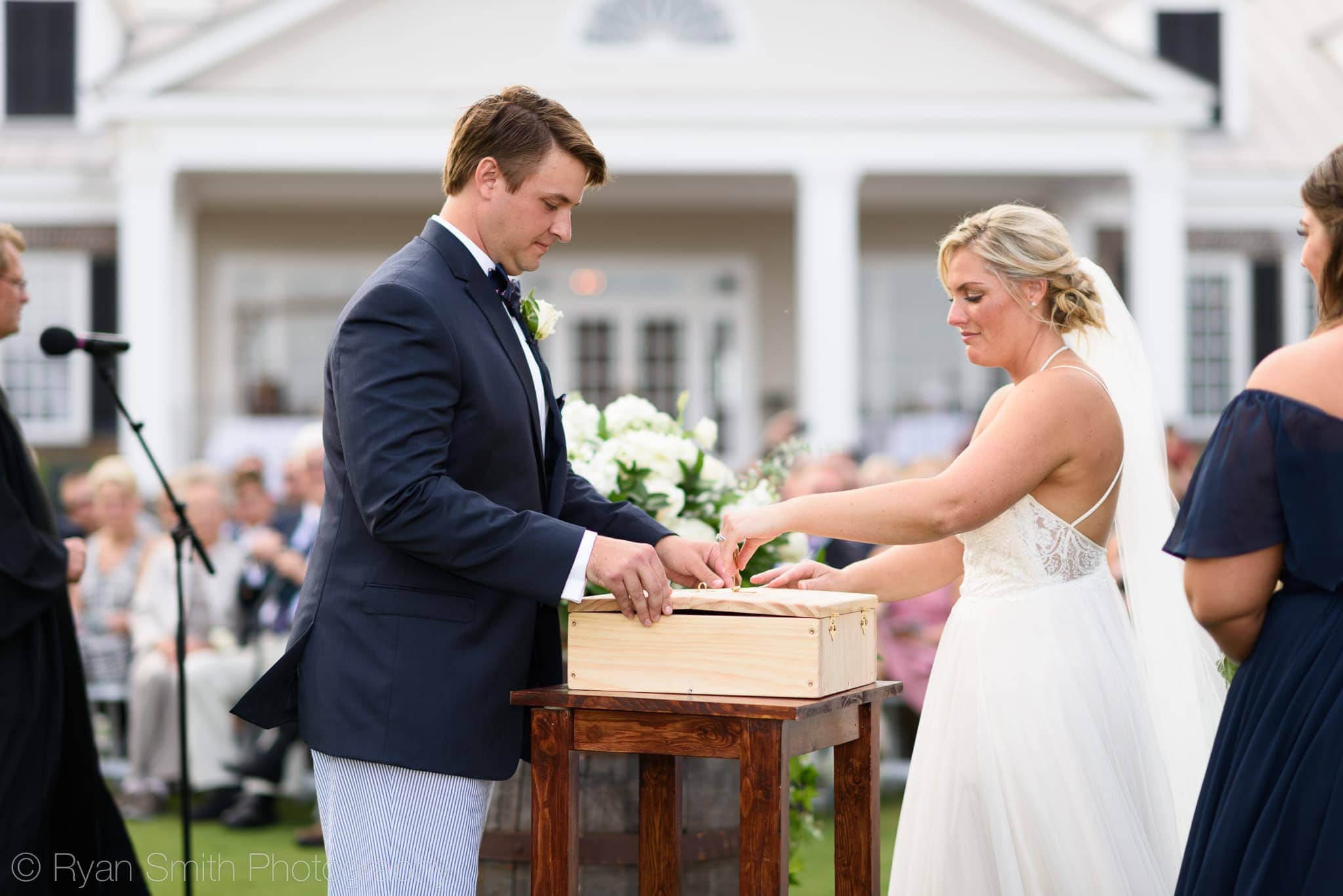 Bride and groom placing letters in box for anniversary  - Pawleys Plantation