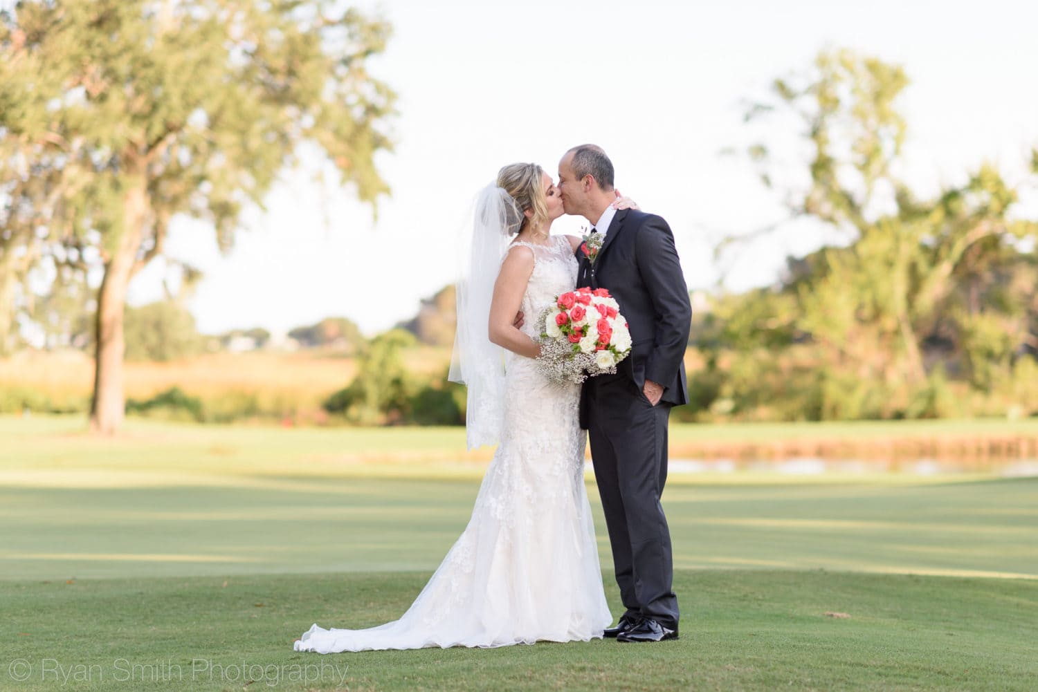 Couple kissing on the golf course - Pawleys Plantation