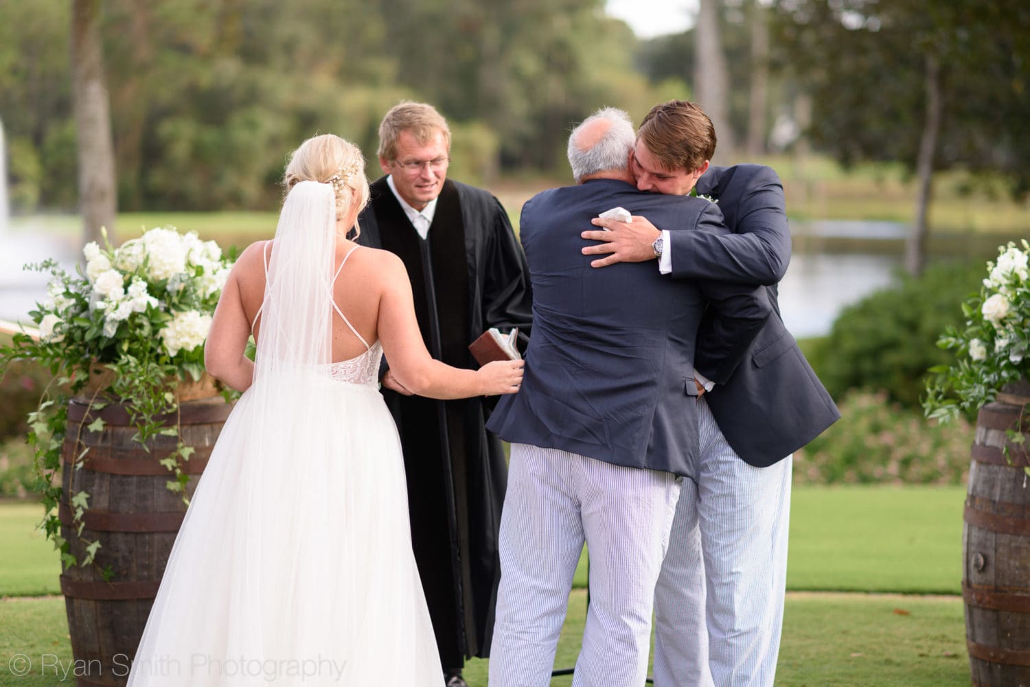 Groom hugging  bride's father - Pawleys Plantation