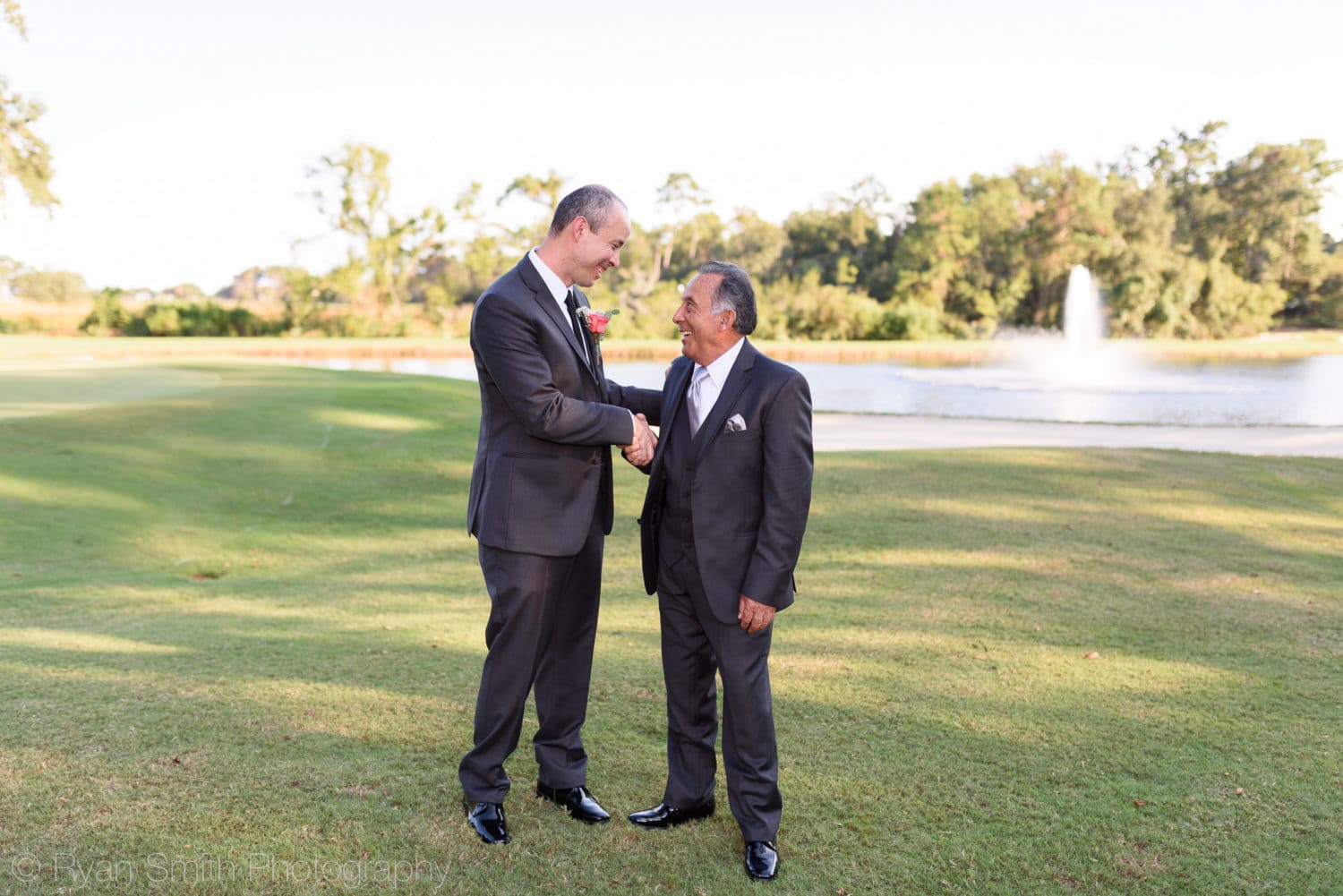Groom shaking hands with father - Pawleys Plantation