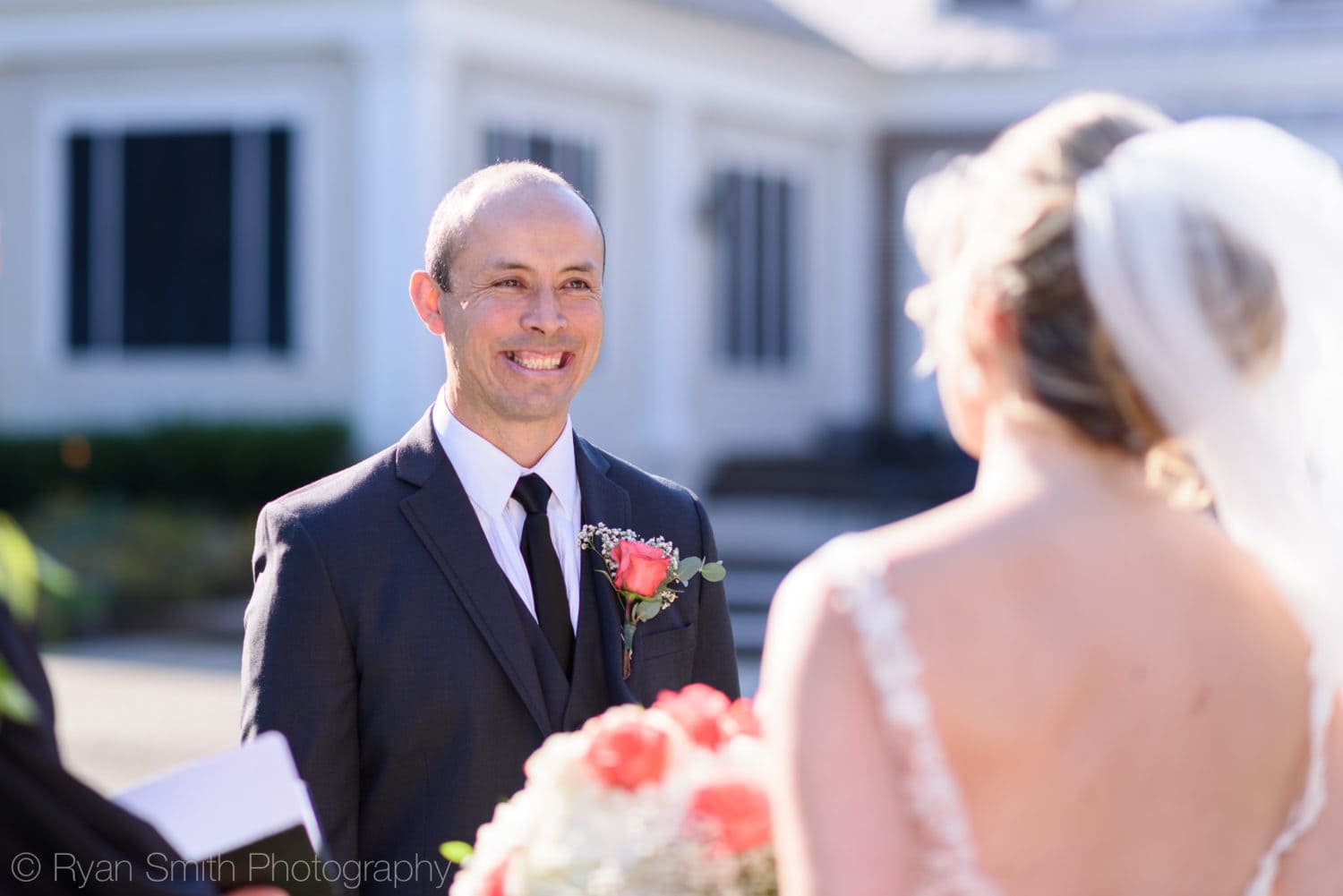 Groom smiling at bride during ceremony - Pawleys Plantation