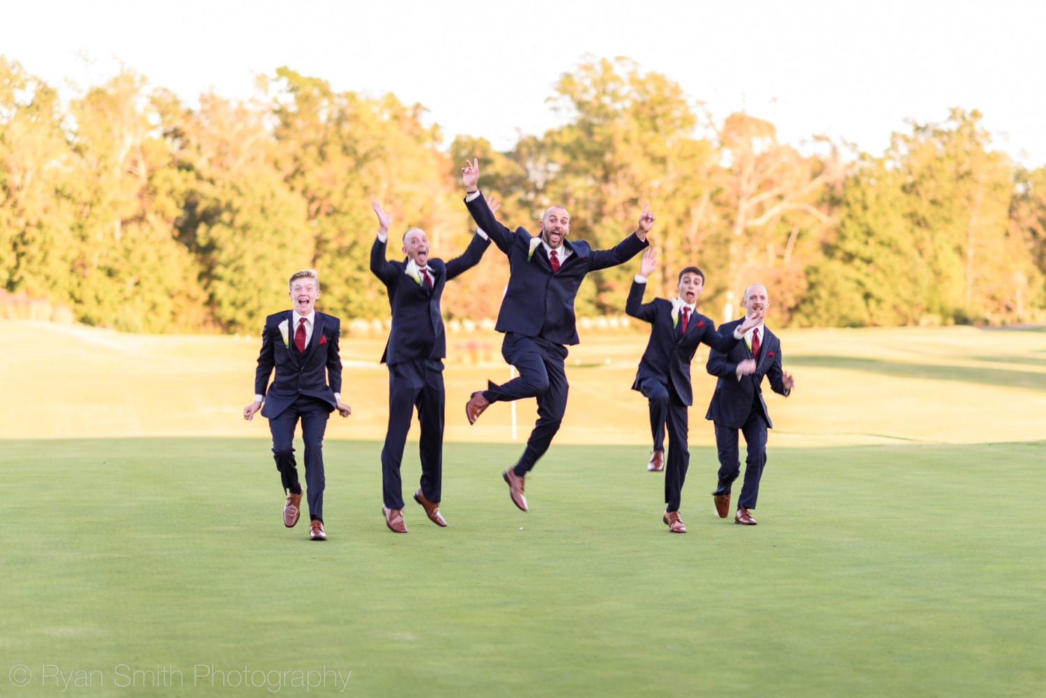 Groom with his sons jumping into the air - Members Club - Grande Dunes