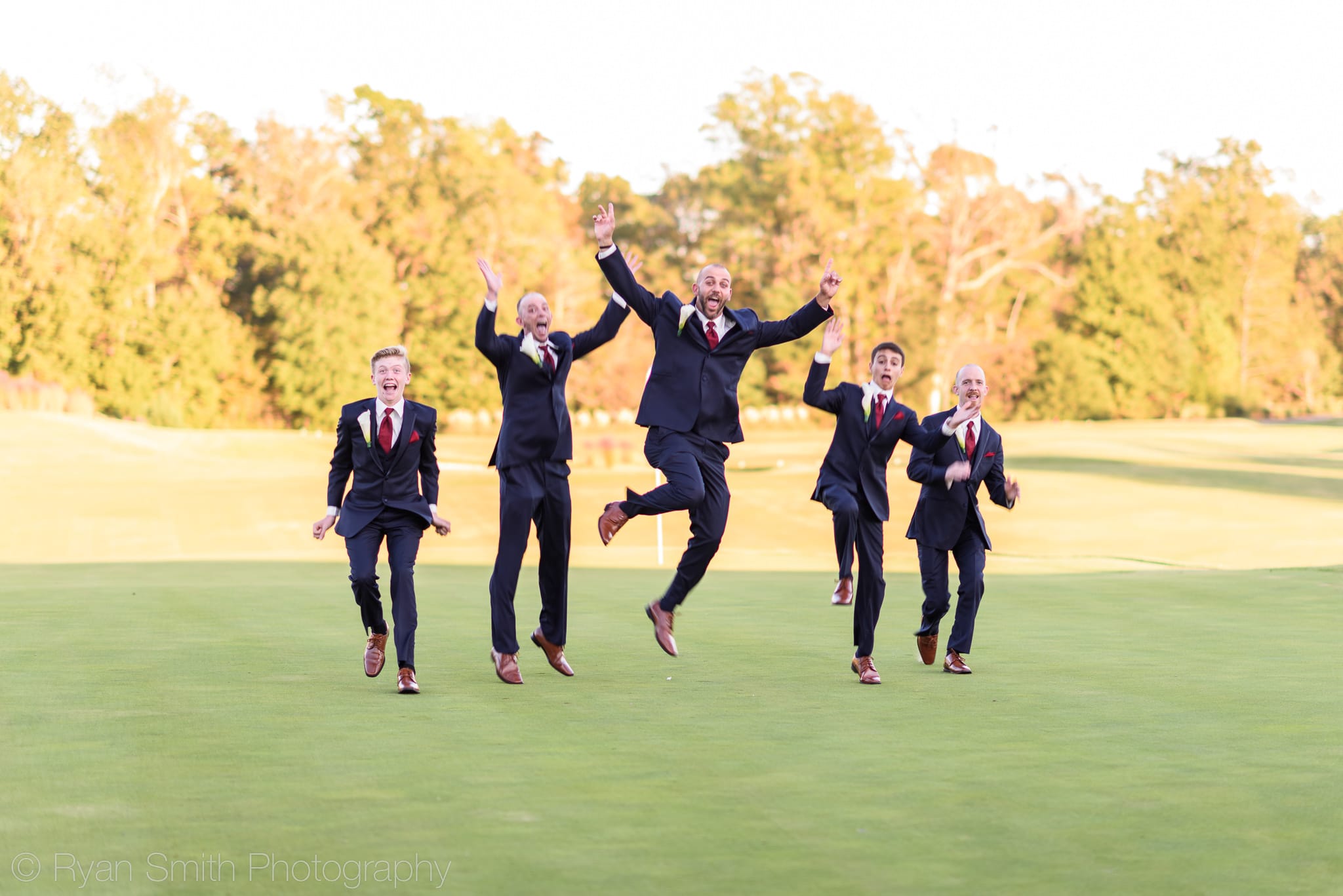 Groom with his sons jumping into the air - Members Club - Grande Dunes