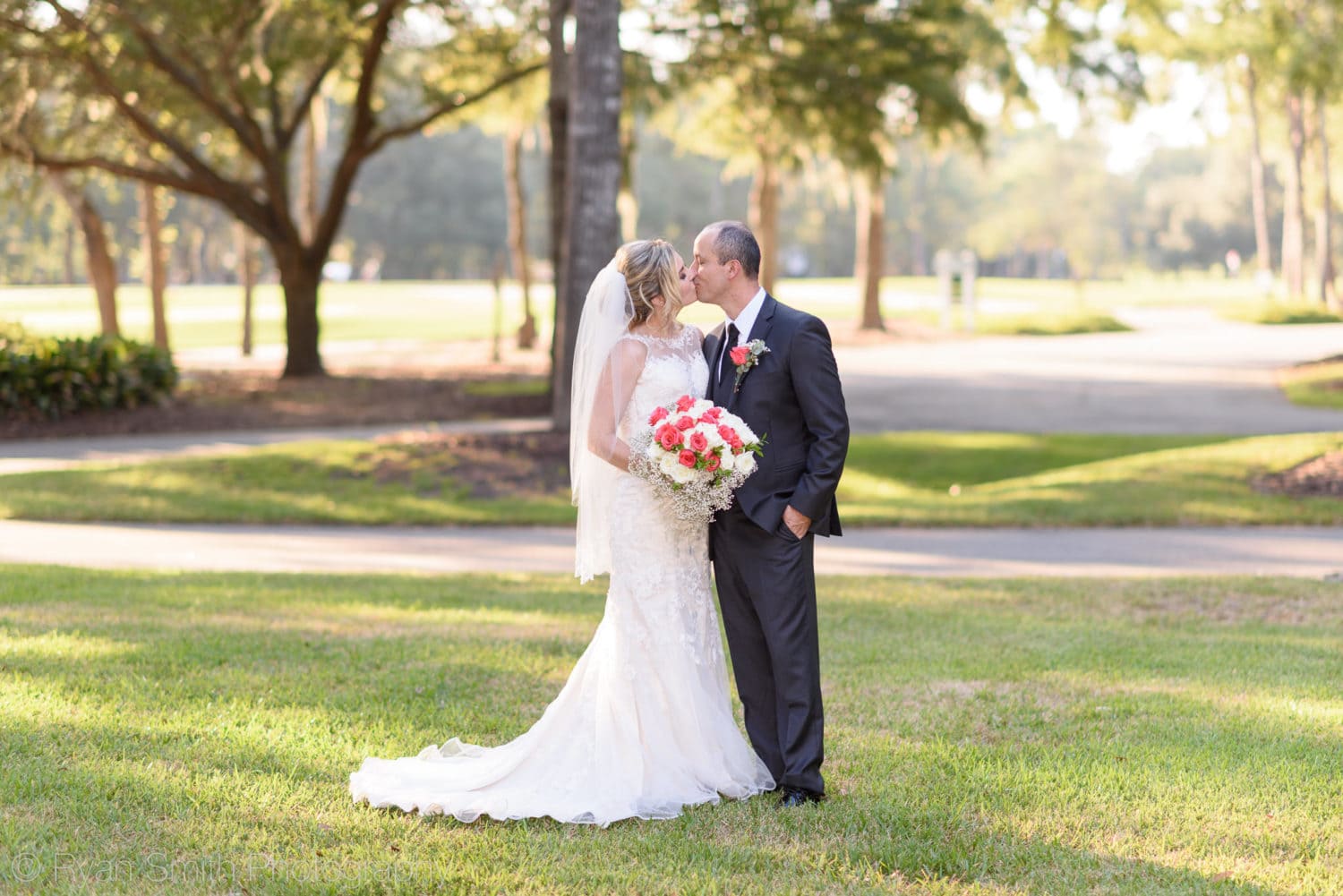 Portraits of bride and groom on the front lawn - Pawleys Plantation