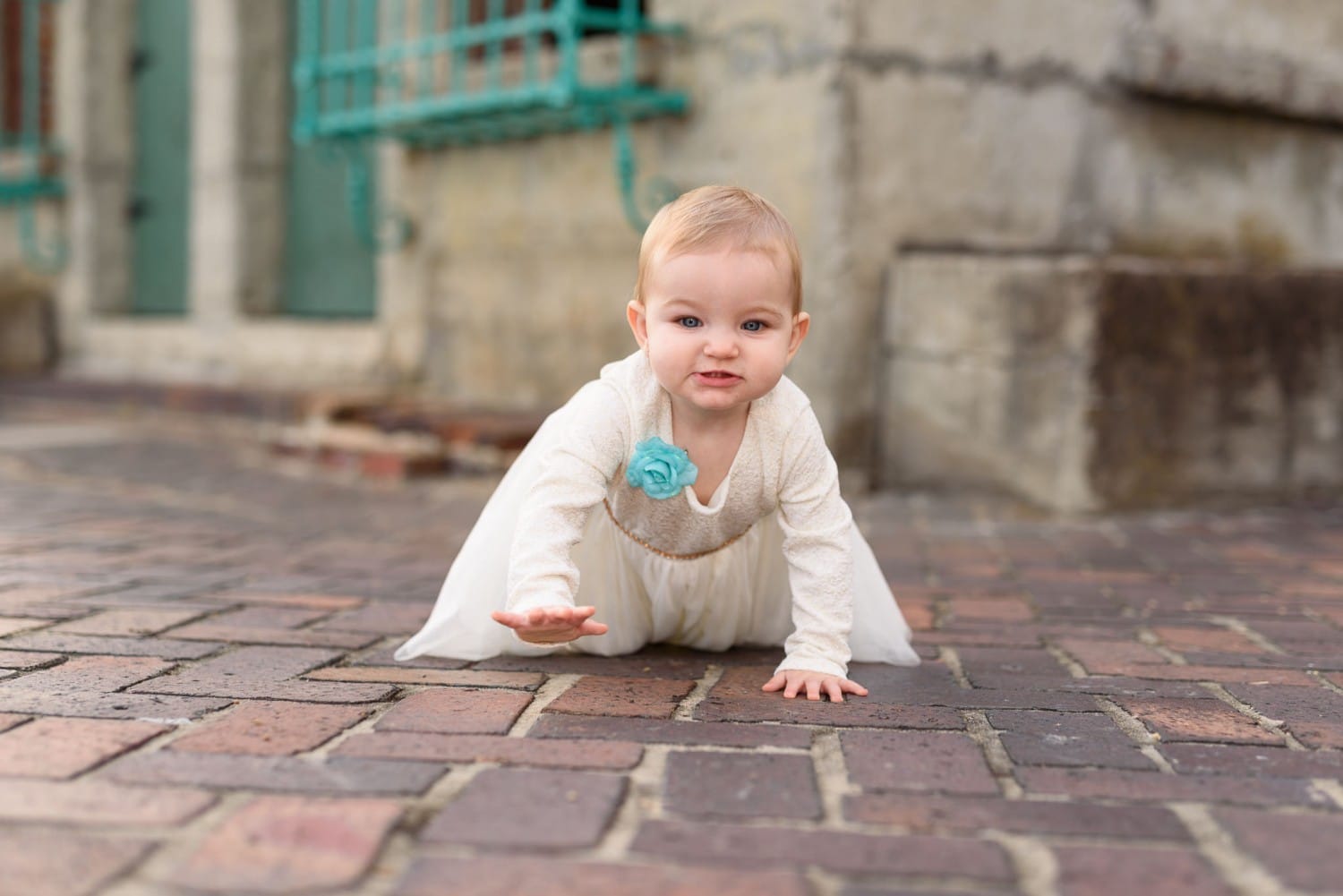 Baby girl crawling behind the Atalaya Castle -