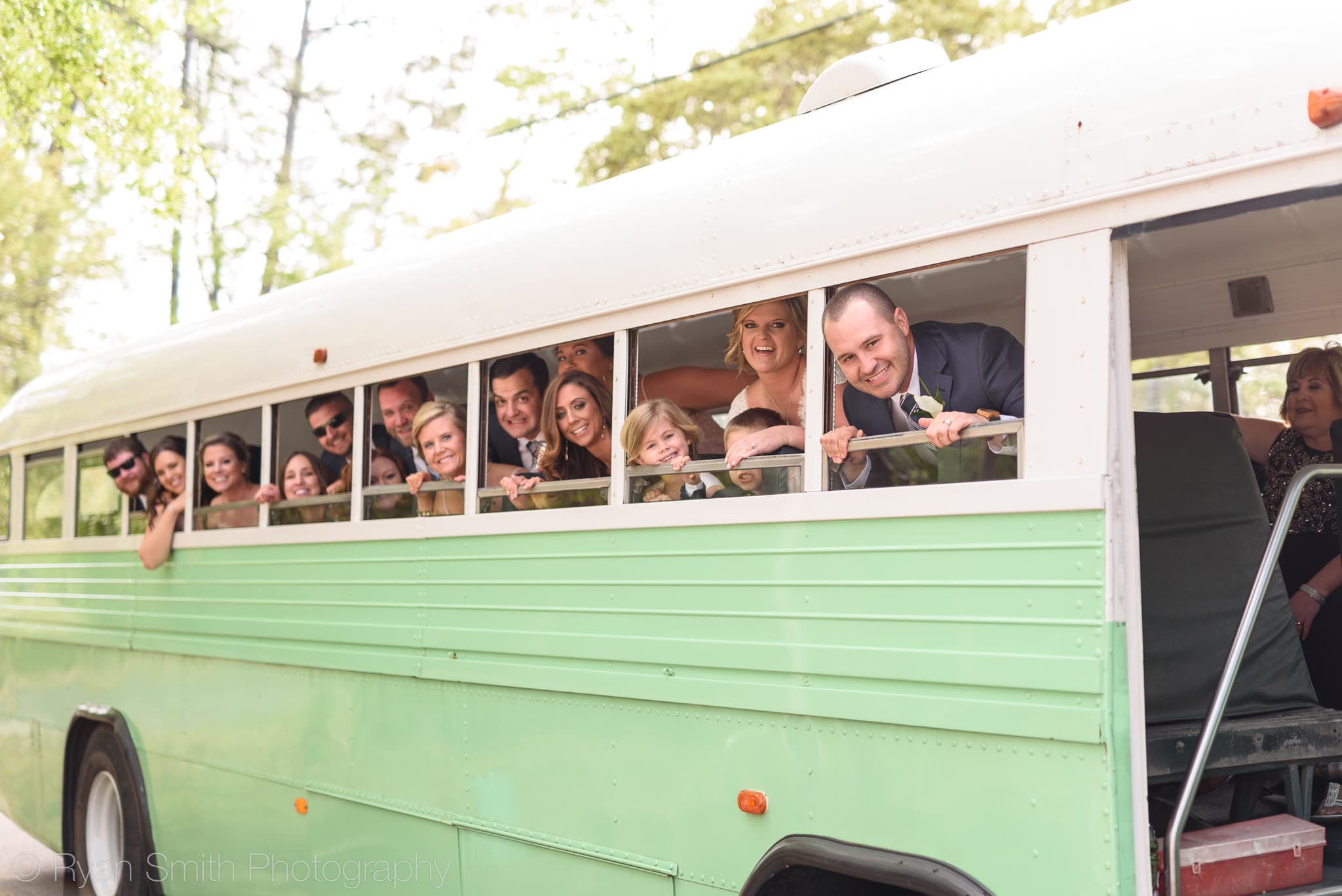 Bridal party looking out the bus windows - Pawleys Plantation