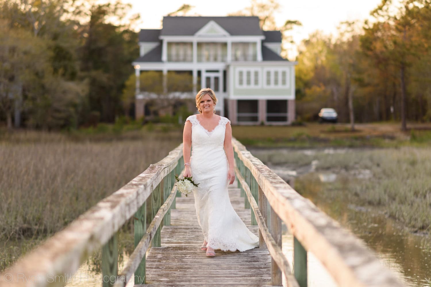 Bridal portrait walking down a marsh walkway - Pawleys Island