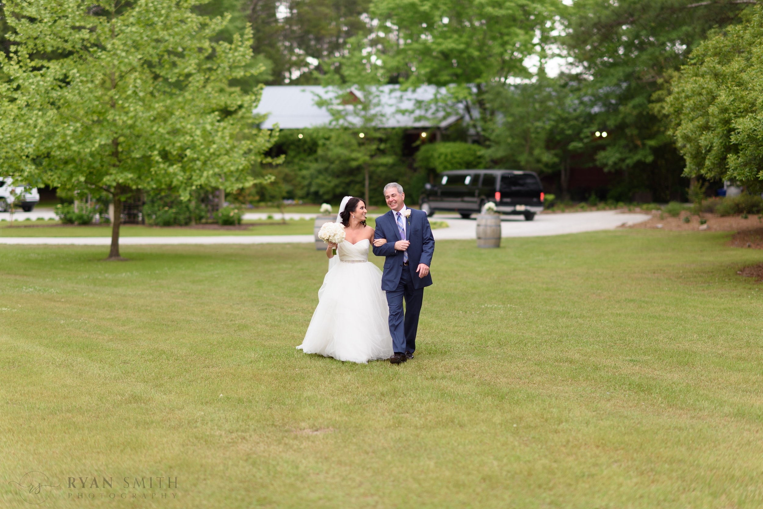 Bride and father walking down the lawn - La Belle Amie Vineyard