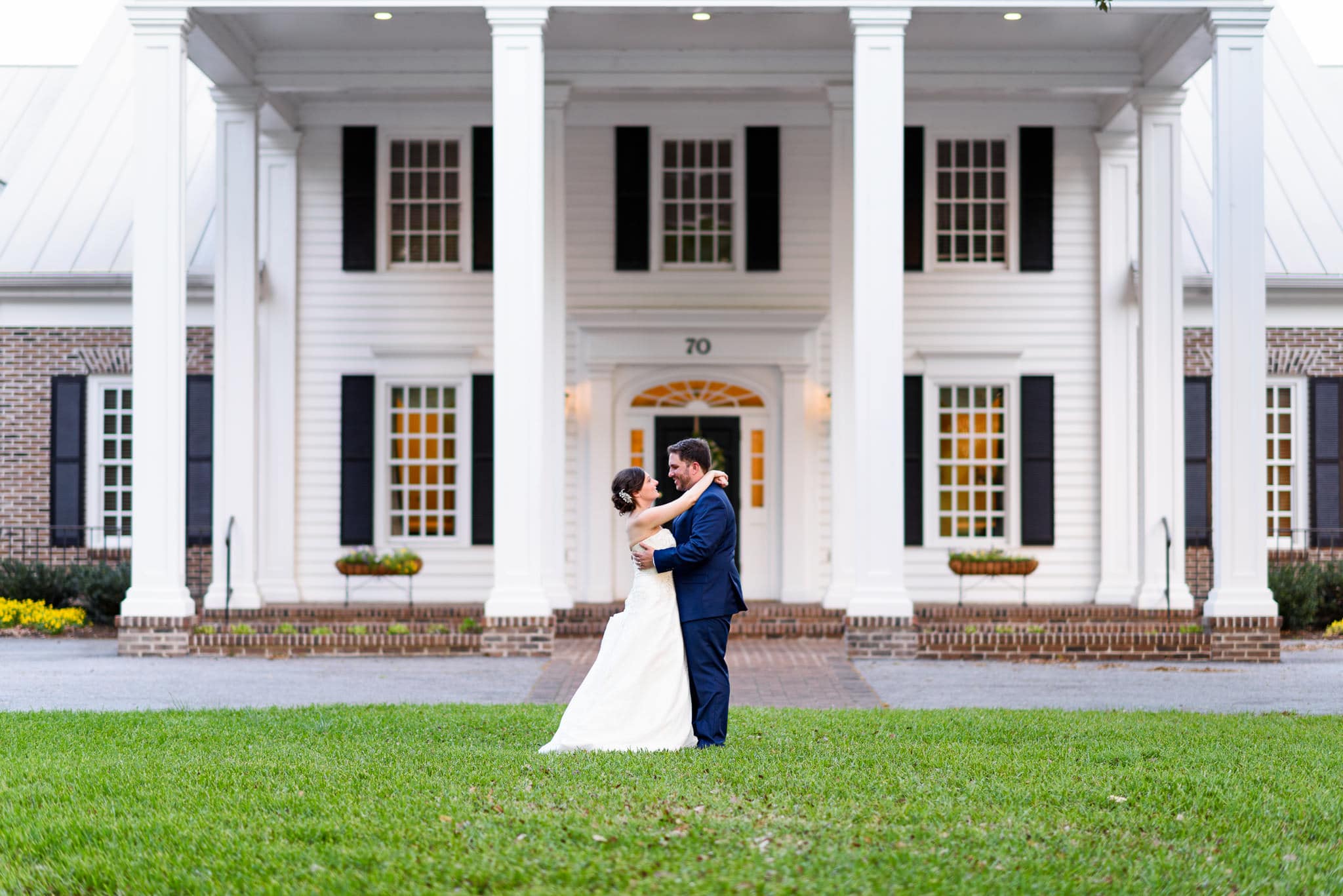 Bride and groom in front of clubhouse - Pawleys Plantation