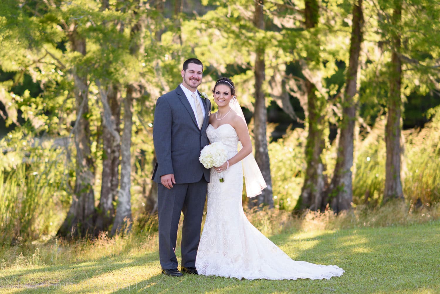 Bride and groom in front of the lake - Upper Mill Plantation